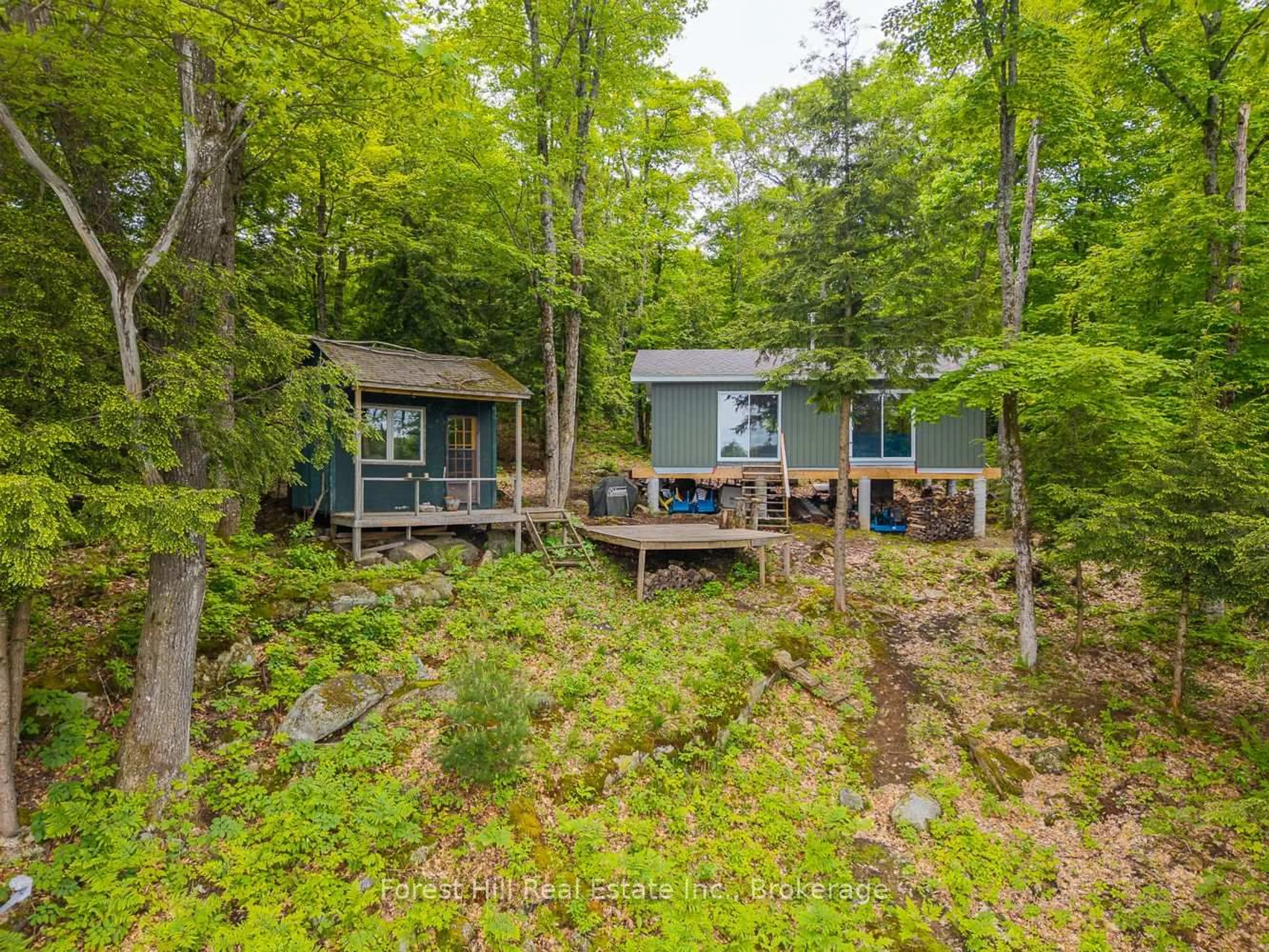 A pic from outside/outdoor area/front of a property/back of a property/a pic from drone, forest/trees view for 60 Hawksview Lane, Seguin Ontario P2A 0B2