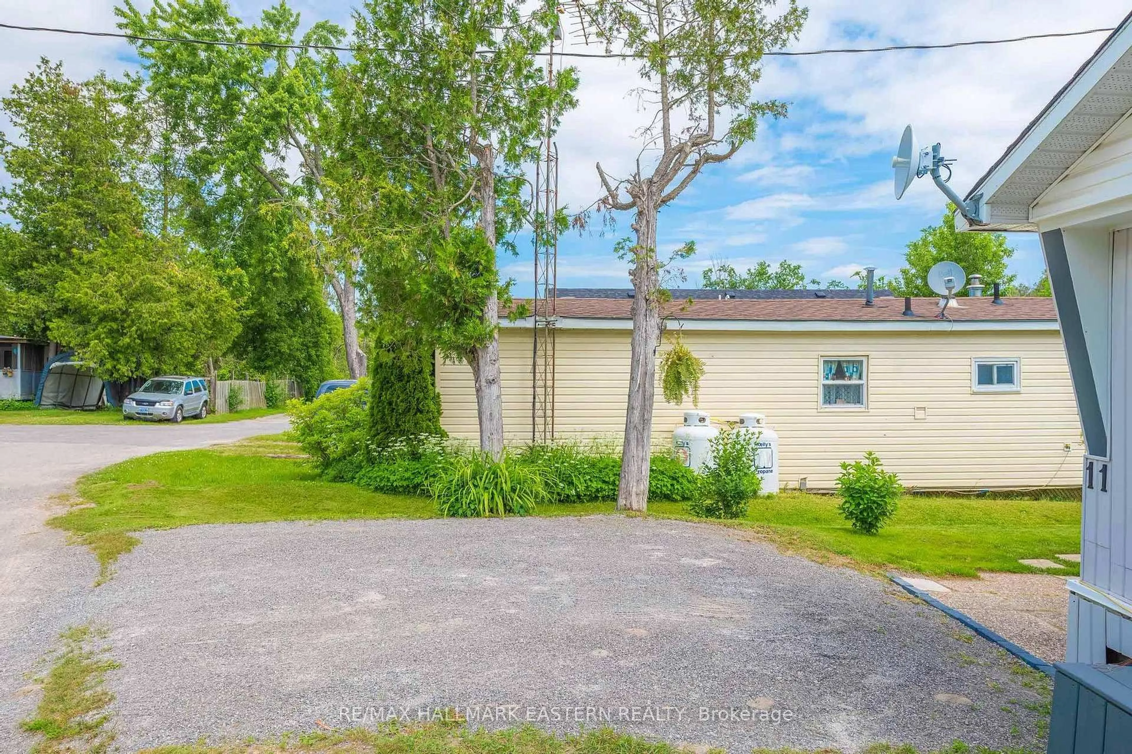 A pic from outside/outdoor area/front of a property/back of a property/a pic from drone, street for 1093 County Rd 28 #11, Otonabee-South Monaghan Ontario K9J 6Y3