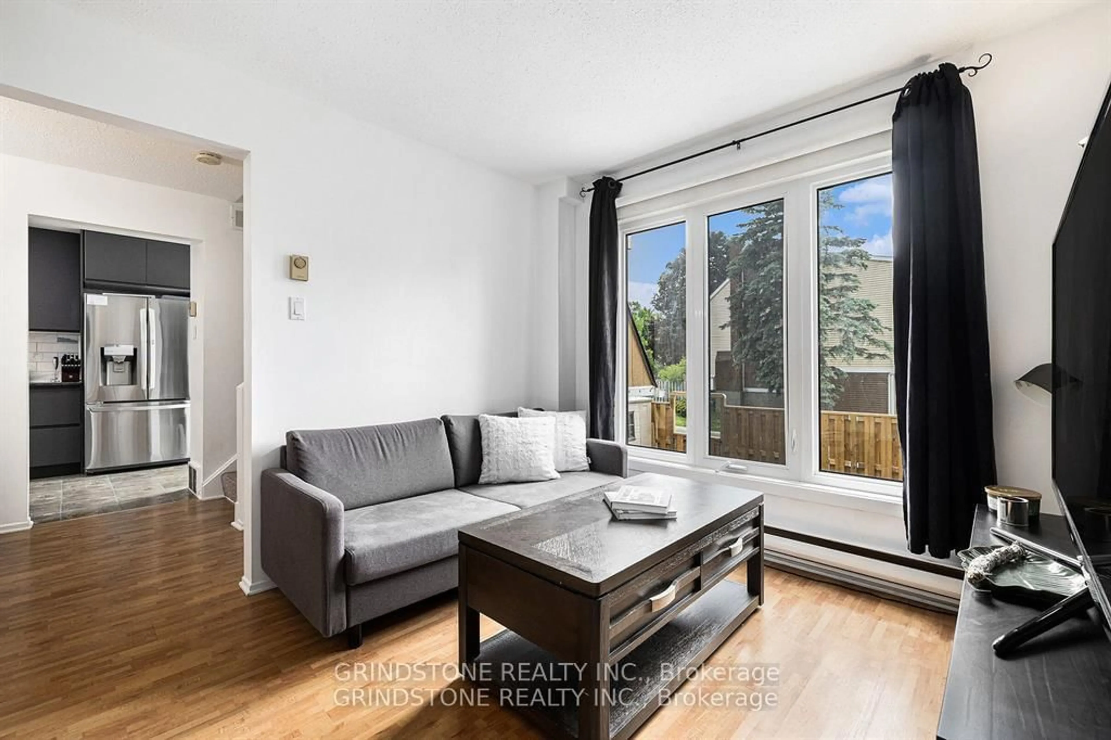 Living room with furniture, wood/laminate floor for 127 Salter Cres, Kanata Ontario K2K 1Y8