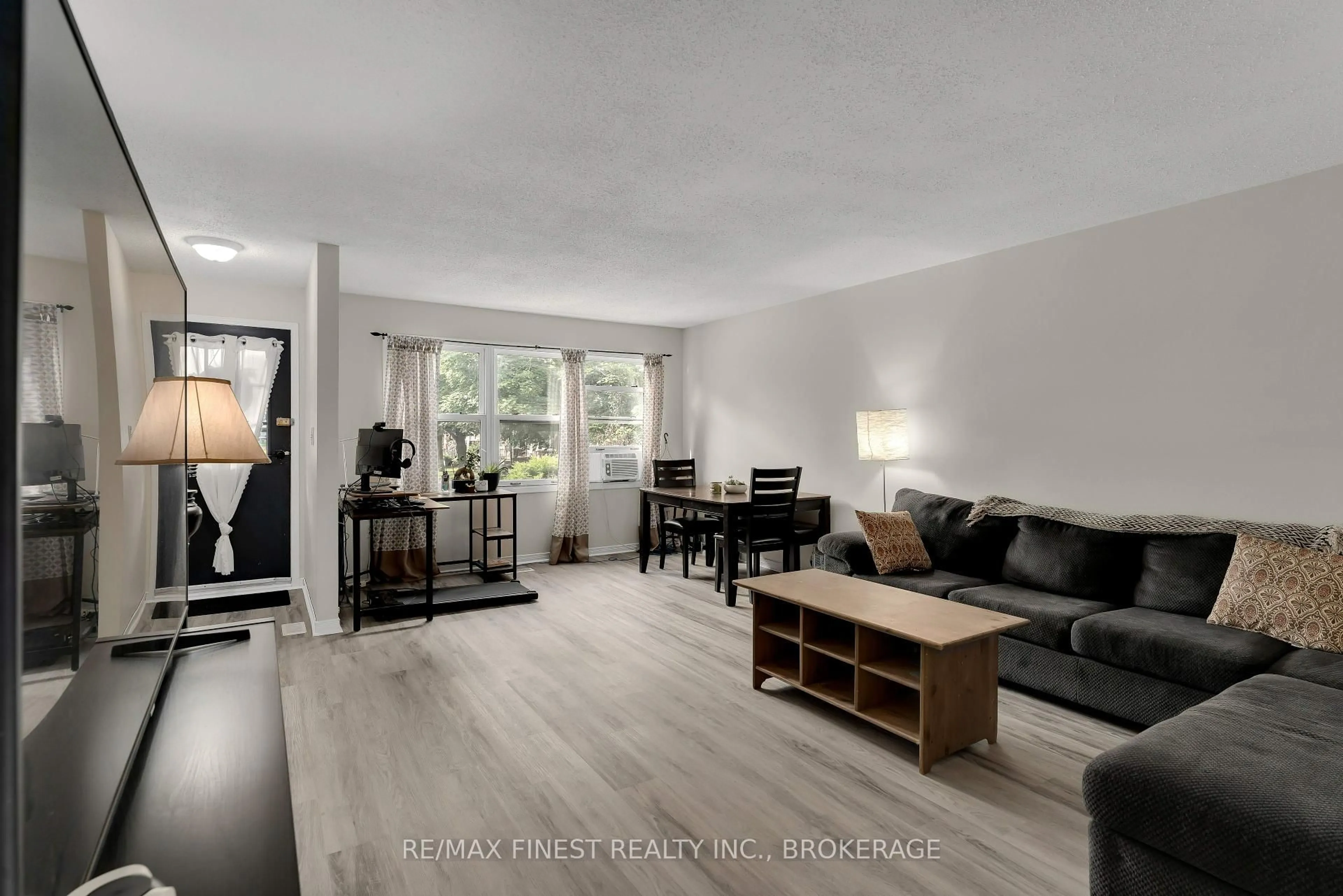 Living room with furniture, wood/laminate floor for 23 Addington St #11, Loyalist Ontario K7N 1C5
