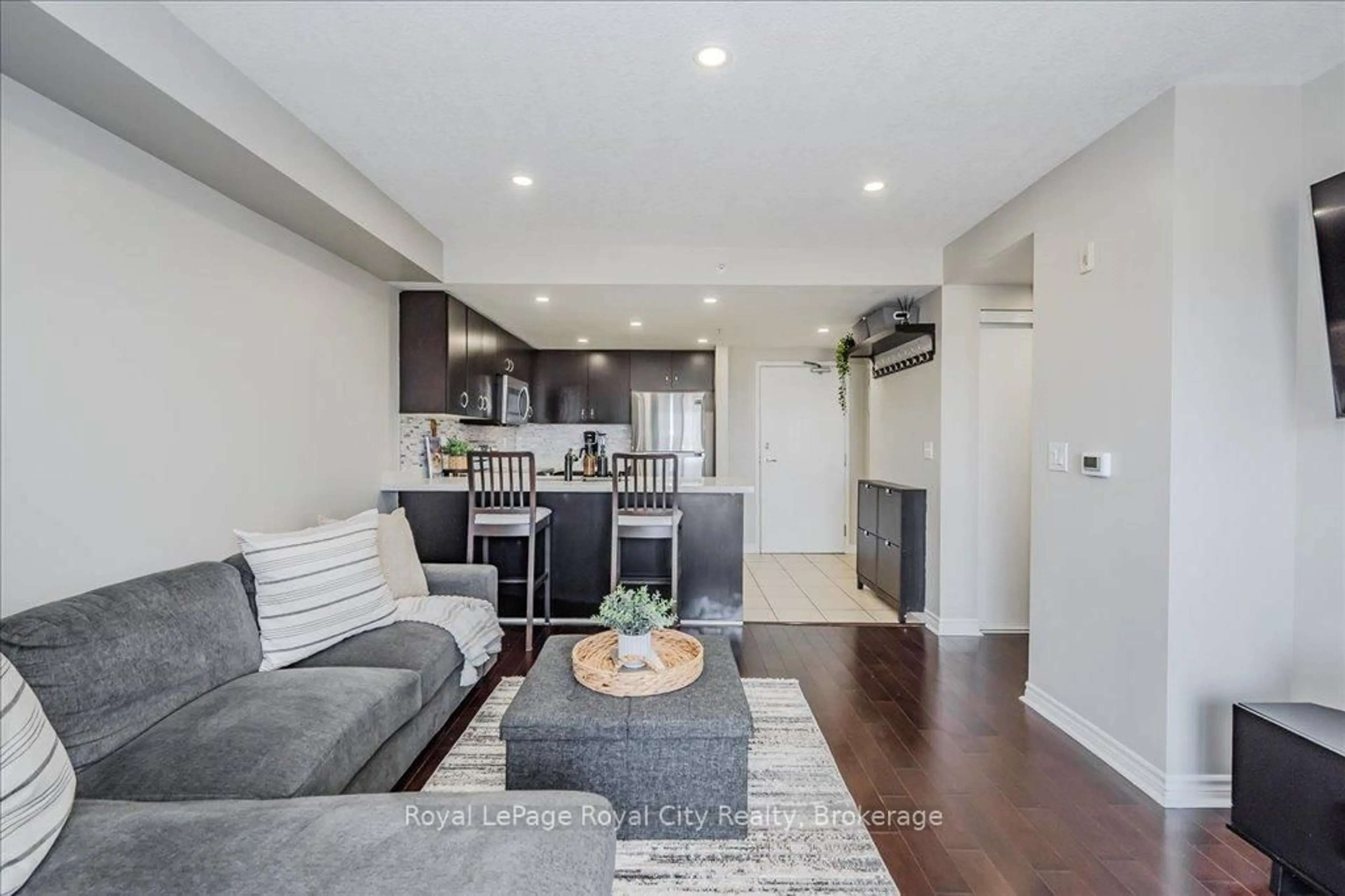 Living room with furniture, wood/laminate floor for 41 Goodwin Dr #403, Guelph Ontario N1L 0E7