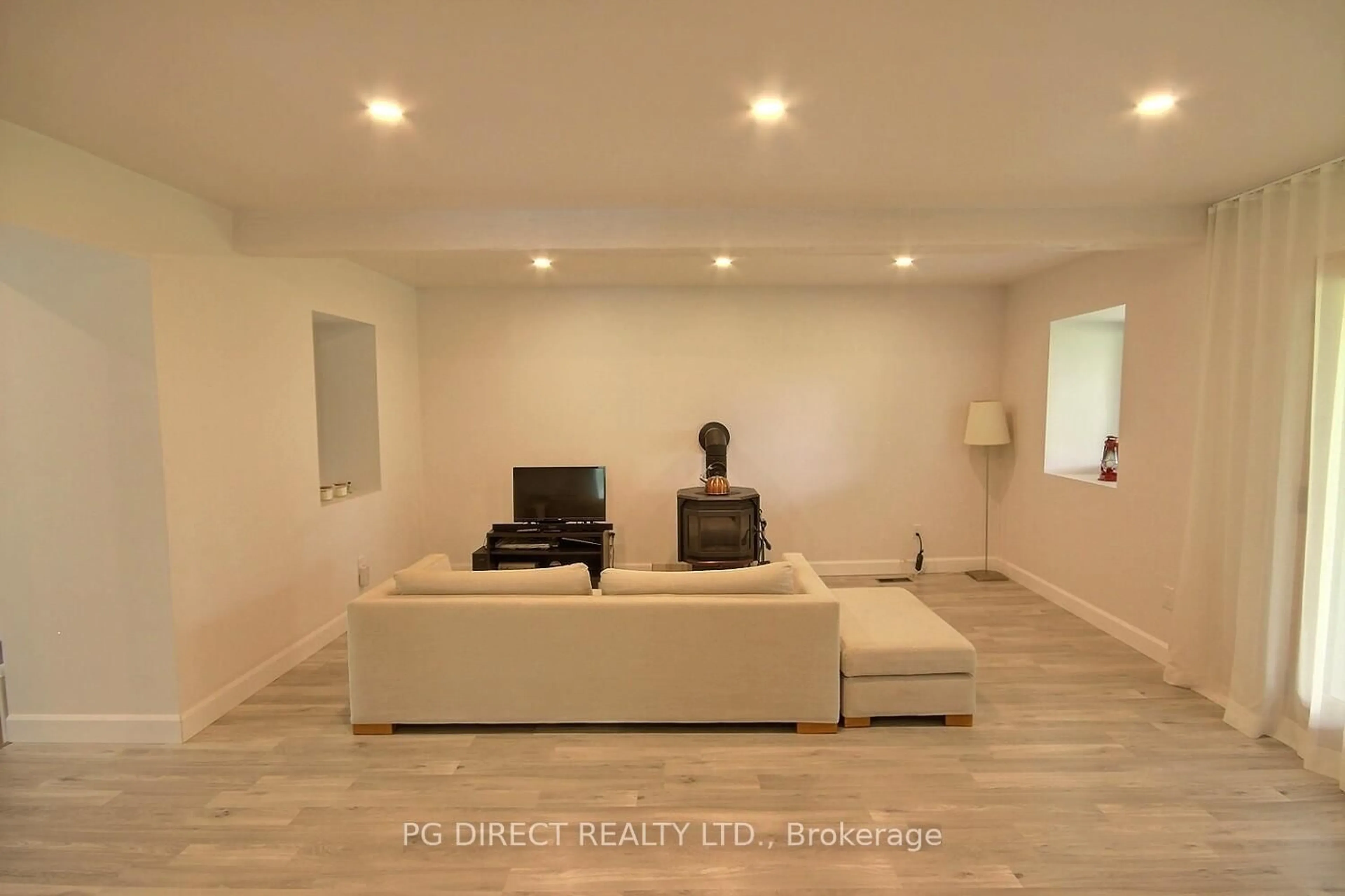 Living room with furniture, wood/laminate floor for 285 County Road 8 Rd, Prince Edward County Ontario K0K 2T0