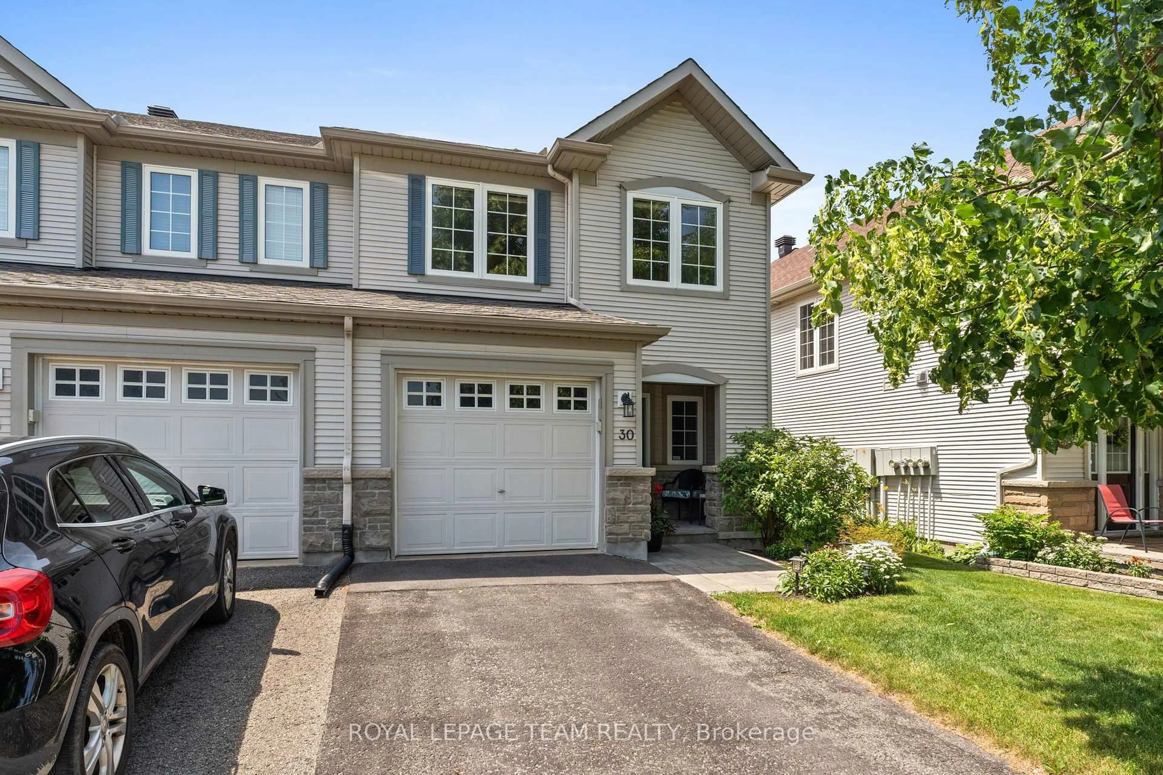 Home with vinyl exterior material, street for 30 Riverstone Dr, Ottawa Ontario K2J 4X7