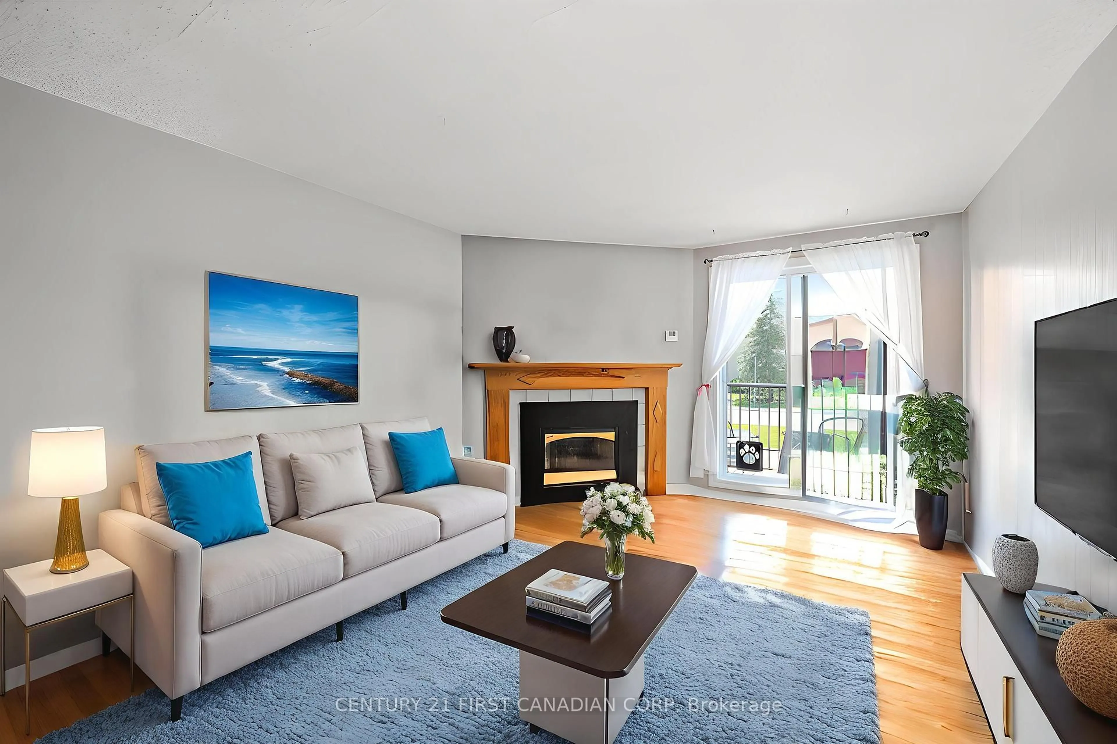 Living room with furniture, wood/laminate floor for 739 Deveron Cres #203, London South Ontario N5Z 4Y1
