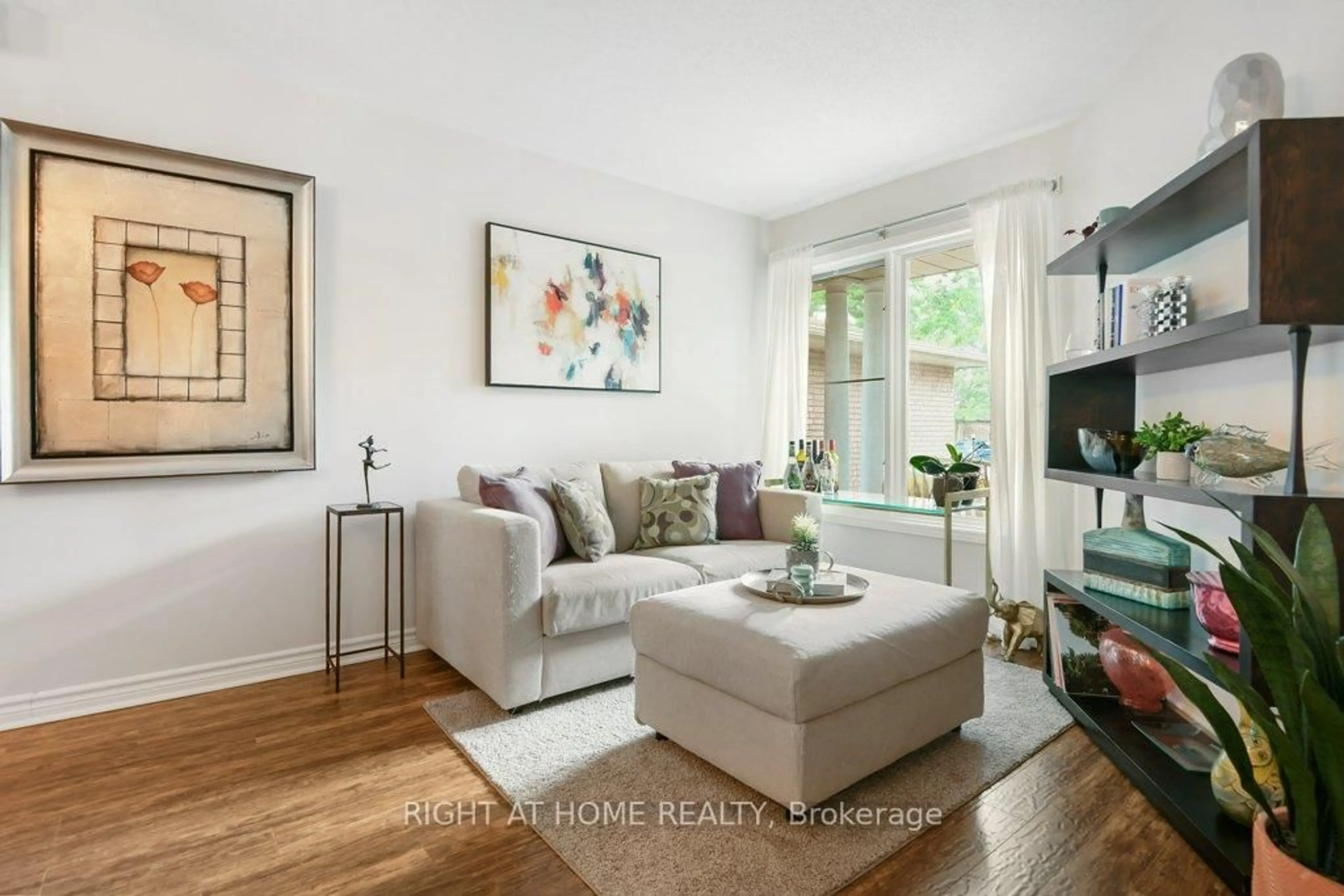 Living room with furniture, wood/laminate floor for 184 Beatrice Dr, Ottawa Ontario K2J 4P1
