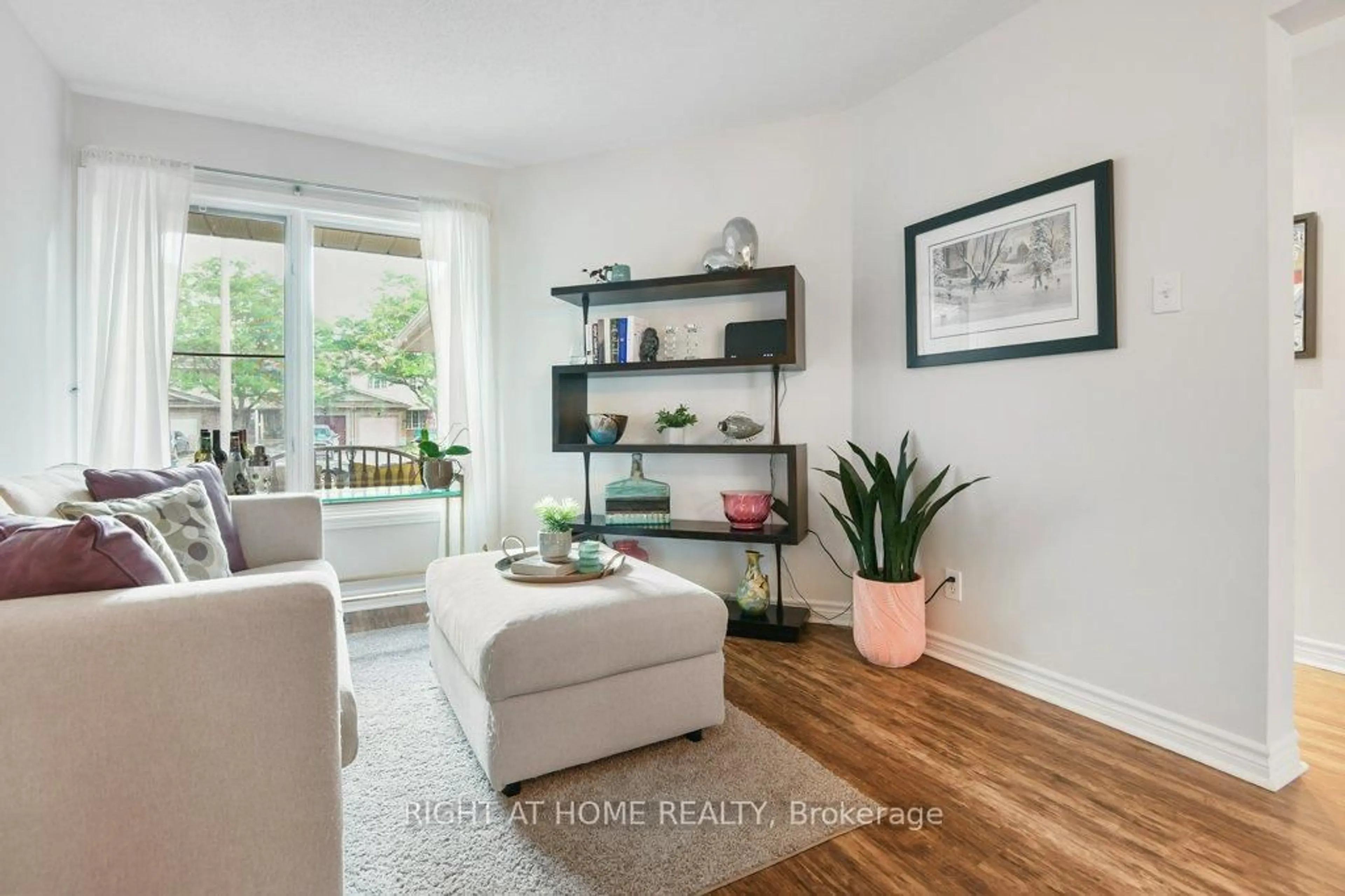 Living room with furniture, wood/laminate floor for 184 Beatrice Dr, Ottawa Ontario K2J 4P1