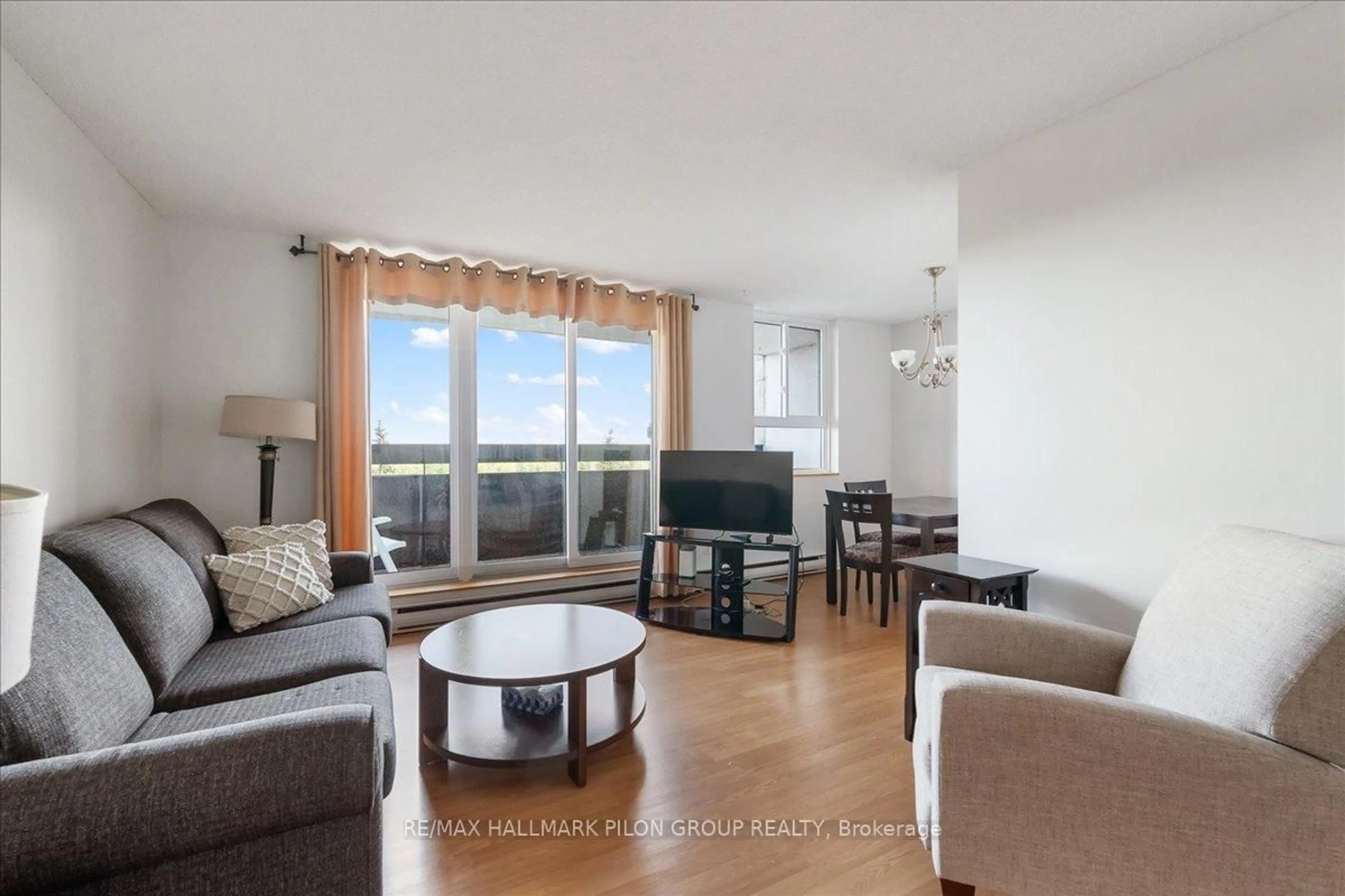 Living room with furniture, wood/laminate floor for 2020 JASMINE Cres #714, Ottawa Ontario K1J 8K5