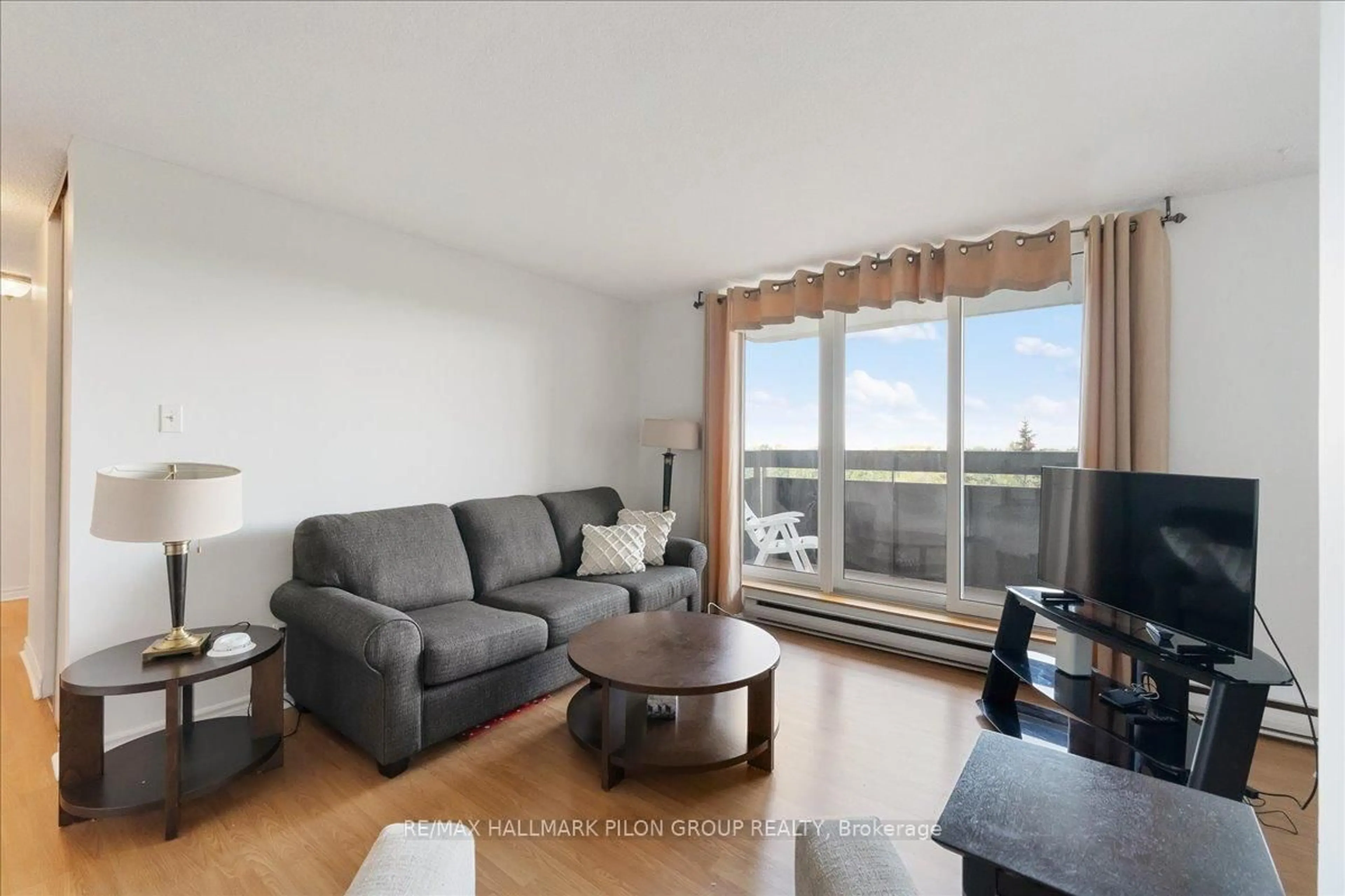 Living room with furniture, wood/laminate floor for 2020 JASMINE Cres #714, Ottawa Ontario K1J 8K5