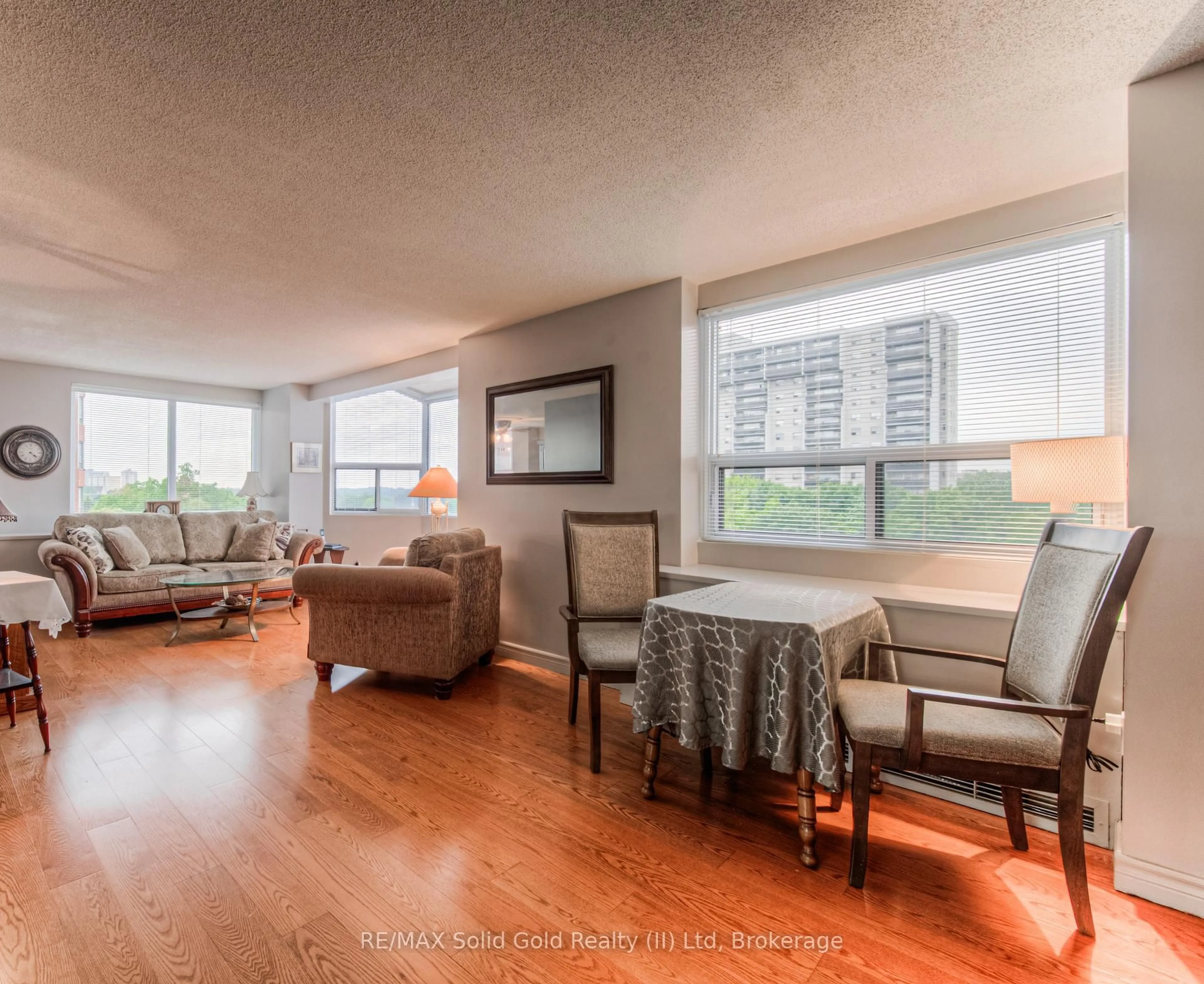 Living room with furniture, wood/laminate floor for 20 Ellen St #611, Kitchener Ontario N2H 6R7