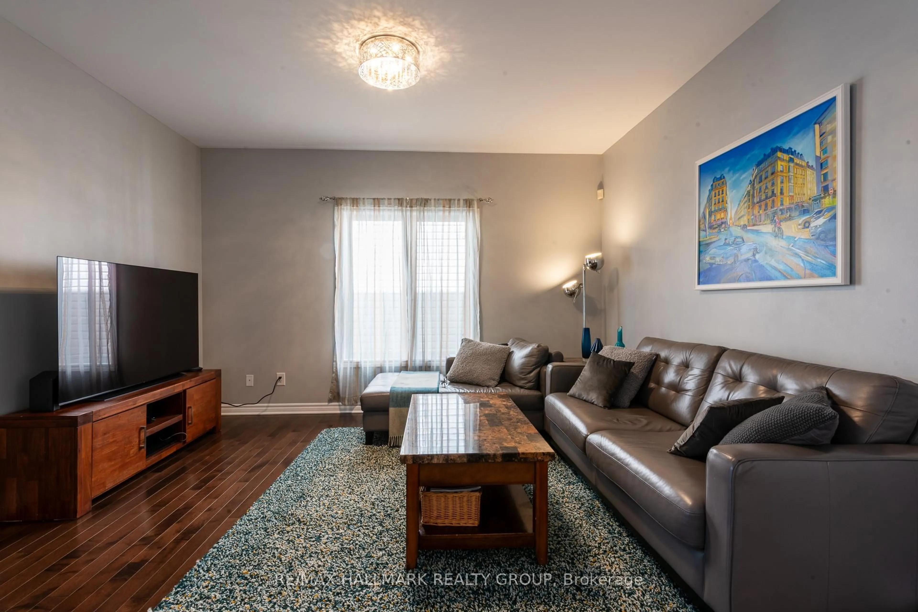Living room with furniture, wood/laminate floor for 217 Fountainhead Dr, Ottawa Ontario K1W 0C2
