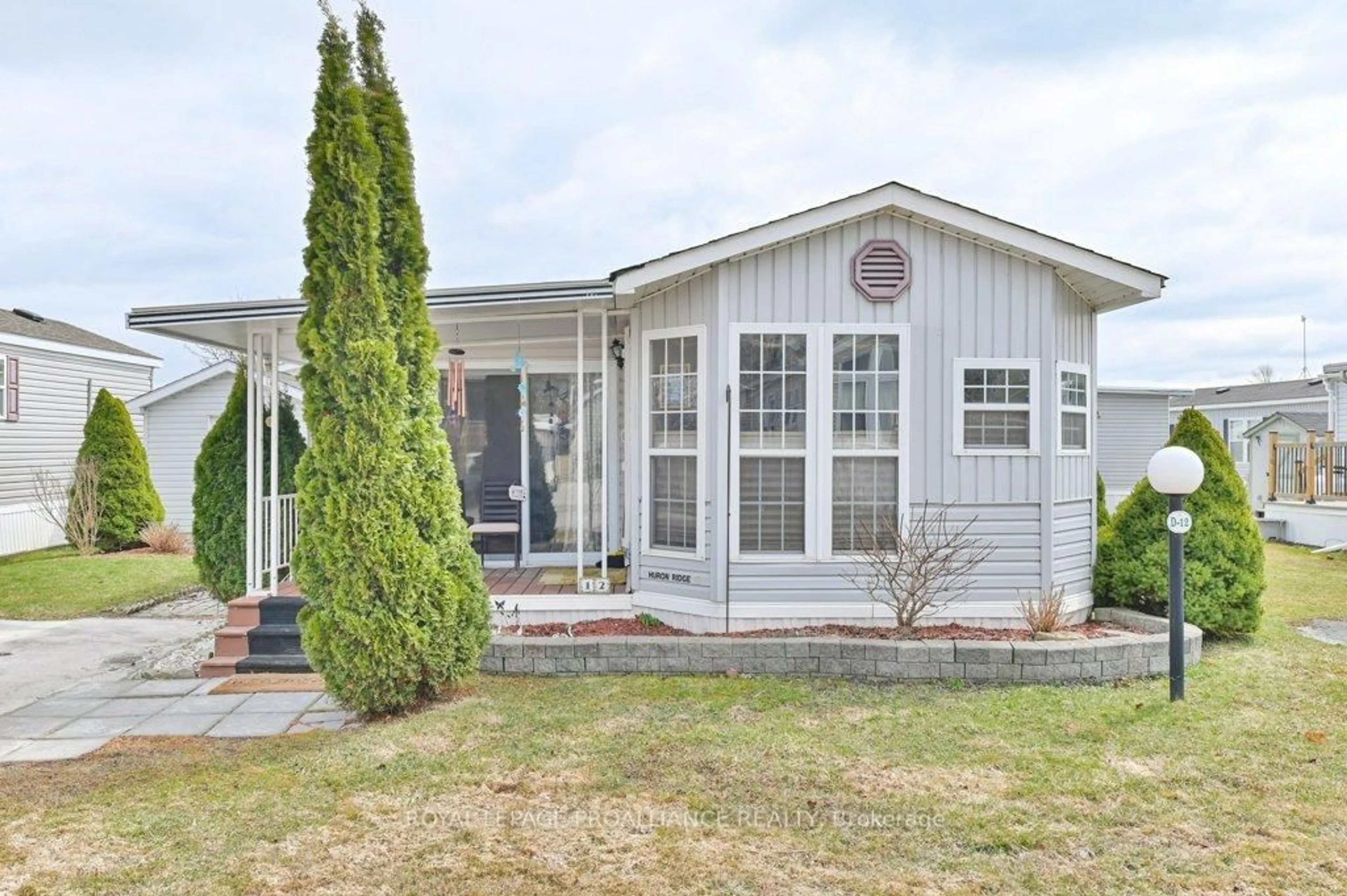 Home with vinyl exterior material, street for 153 County Road 27 #D12, Prince Edward County Ontario K0K 1T0