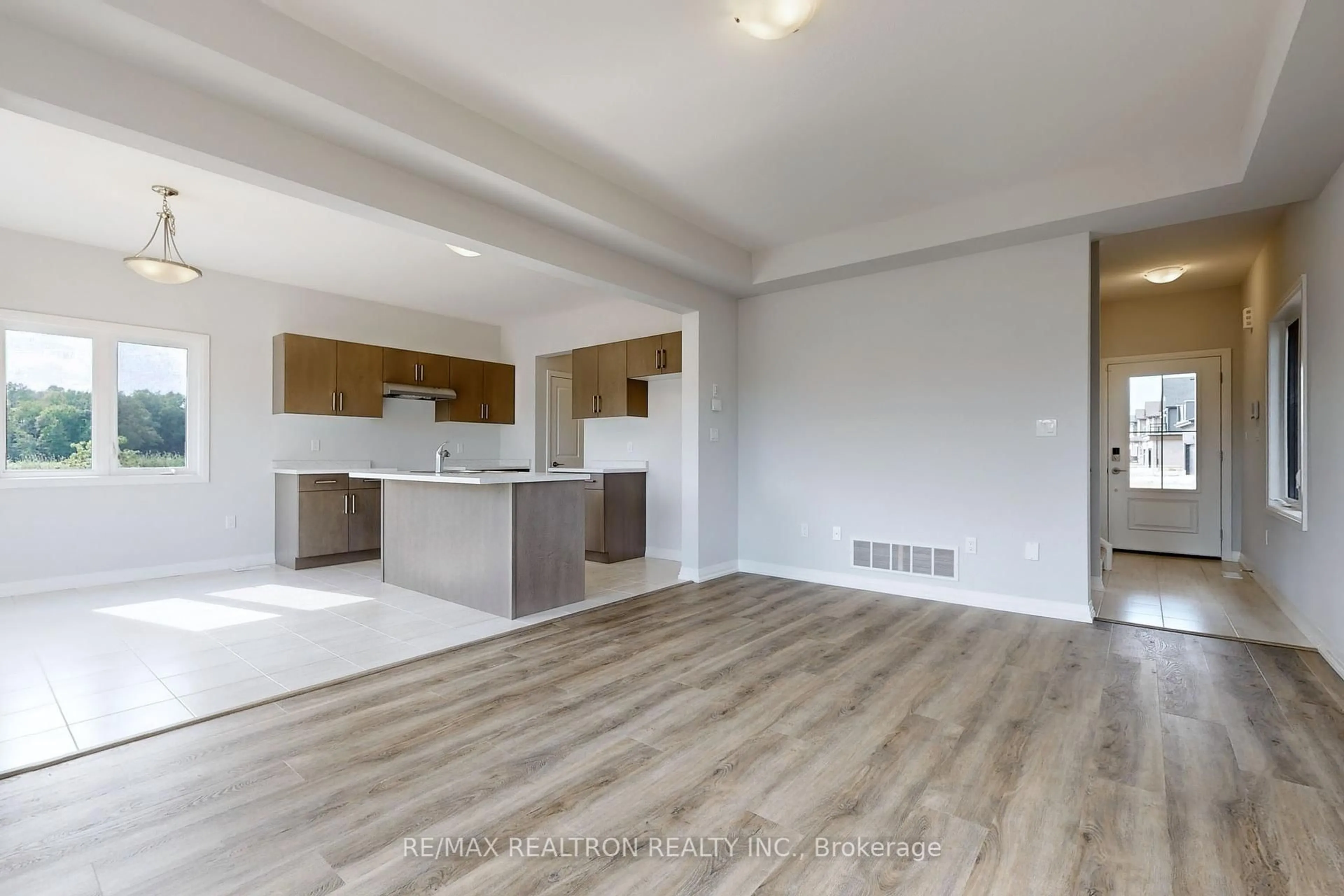 Open concept kitchen, wood/laminate floor for 7461 Majestic Tr, Niagara Falls Ontario L2H 0K7