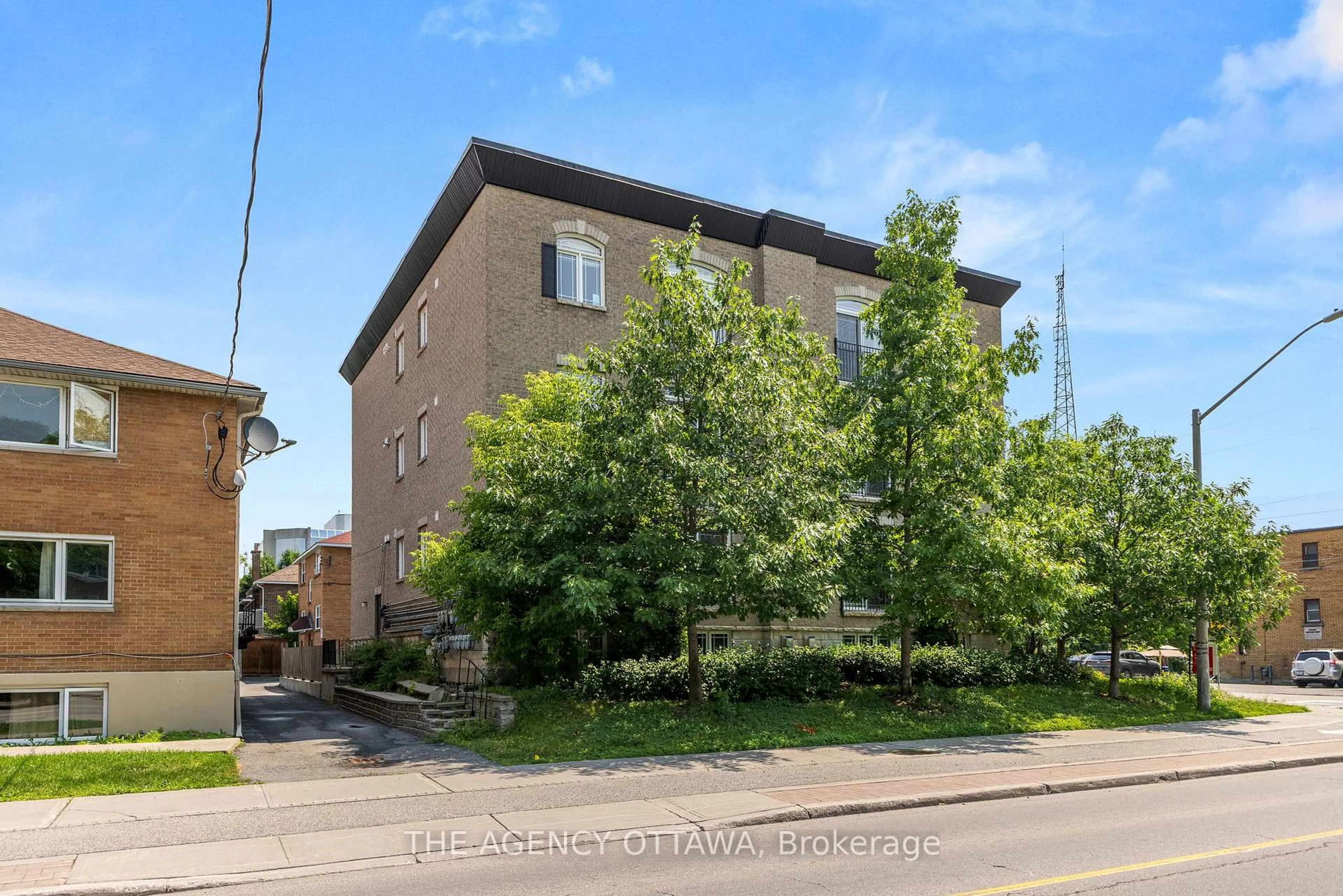 A pic from outside/outdoor area/front of a property/back of a property/a pic from drone, street for 711 CHURCHILL Ave #203, Ottawa Ontario K1Z 7J9