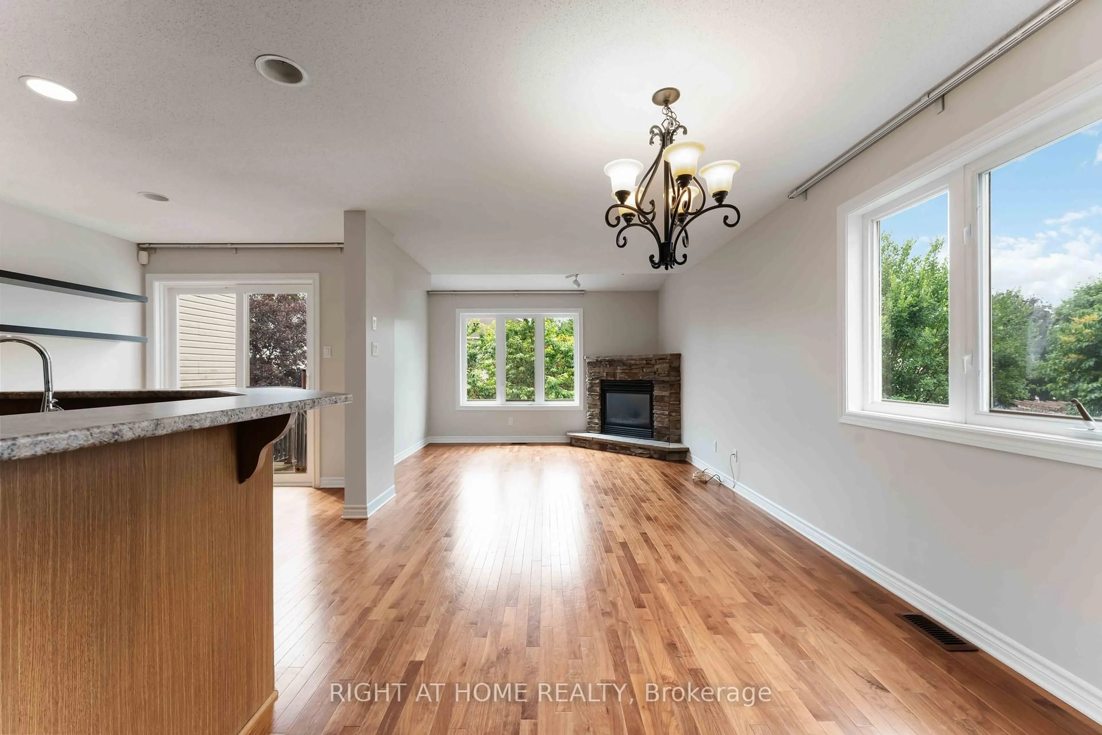 Open concept kitchen, wood/laminate floor for 218 Tandalee Cres, Ottawa Ontario K2M 0A2