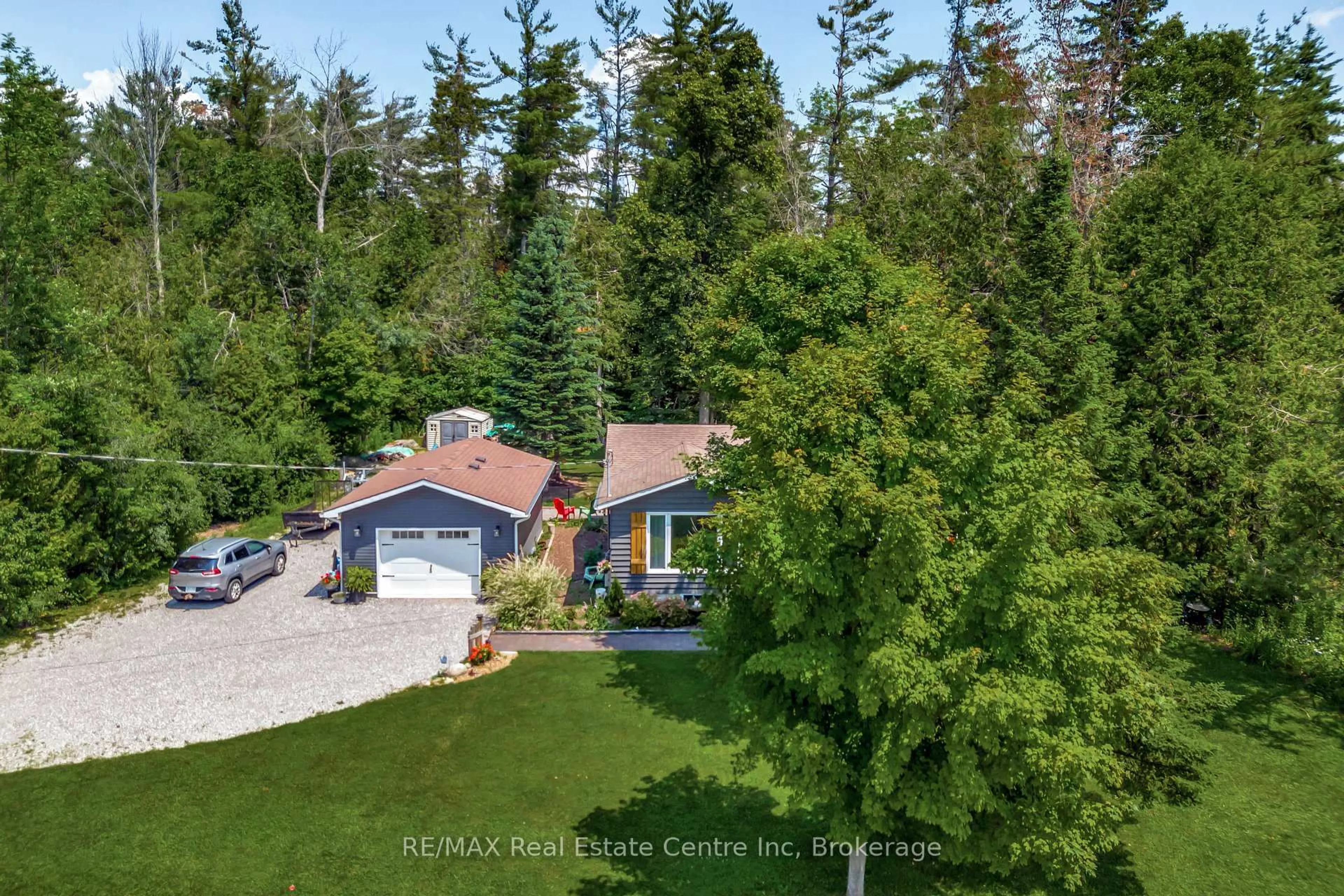A pic from outside/outdoor area/front of a property/back of a property/a pic from drone, forest/trees view for 33 Graham Dr, Kawartha Lakes Ontario K0M 1N0