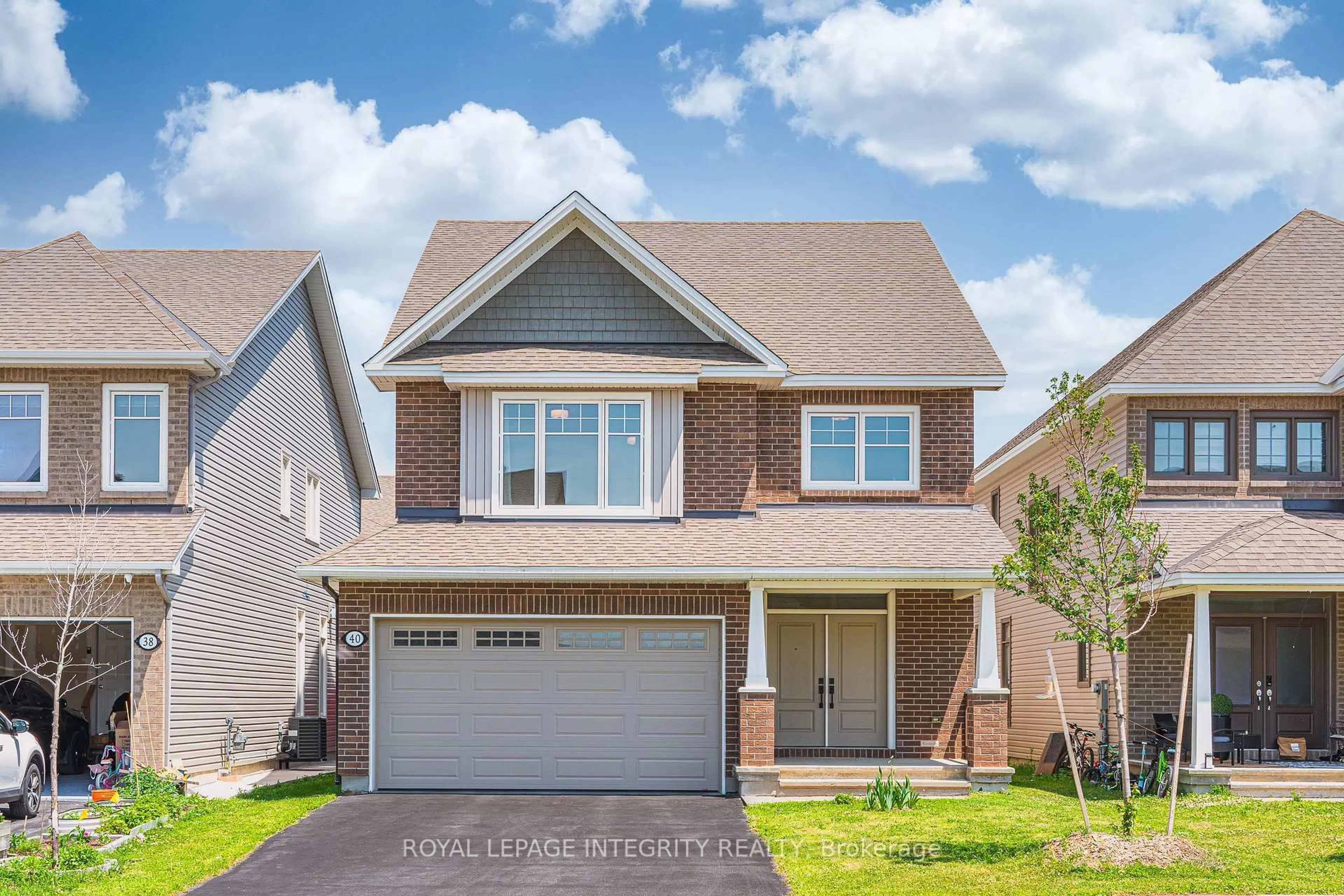 Home with brick exterior material, street for 40 Aconitum Way, Ottawa Ontario K1T 0R8