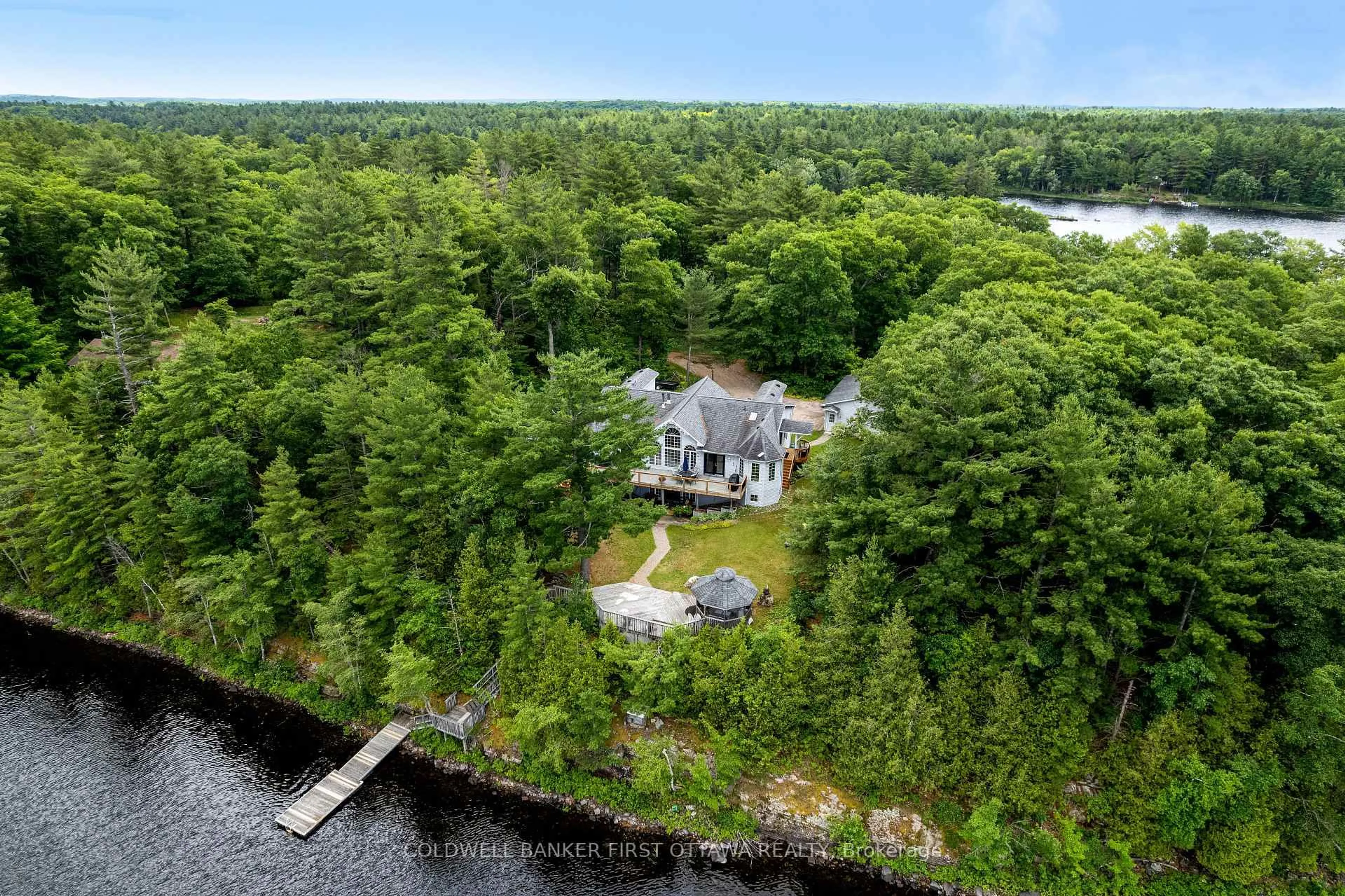 A pic from outside/outdoor area/front of a property/back of a property/a pic from drone, water/lake/river/ocean view for 1718 Blue Heron Rdge, Arden Ontario K0H 1B0