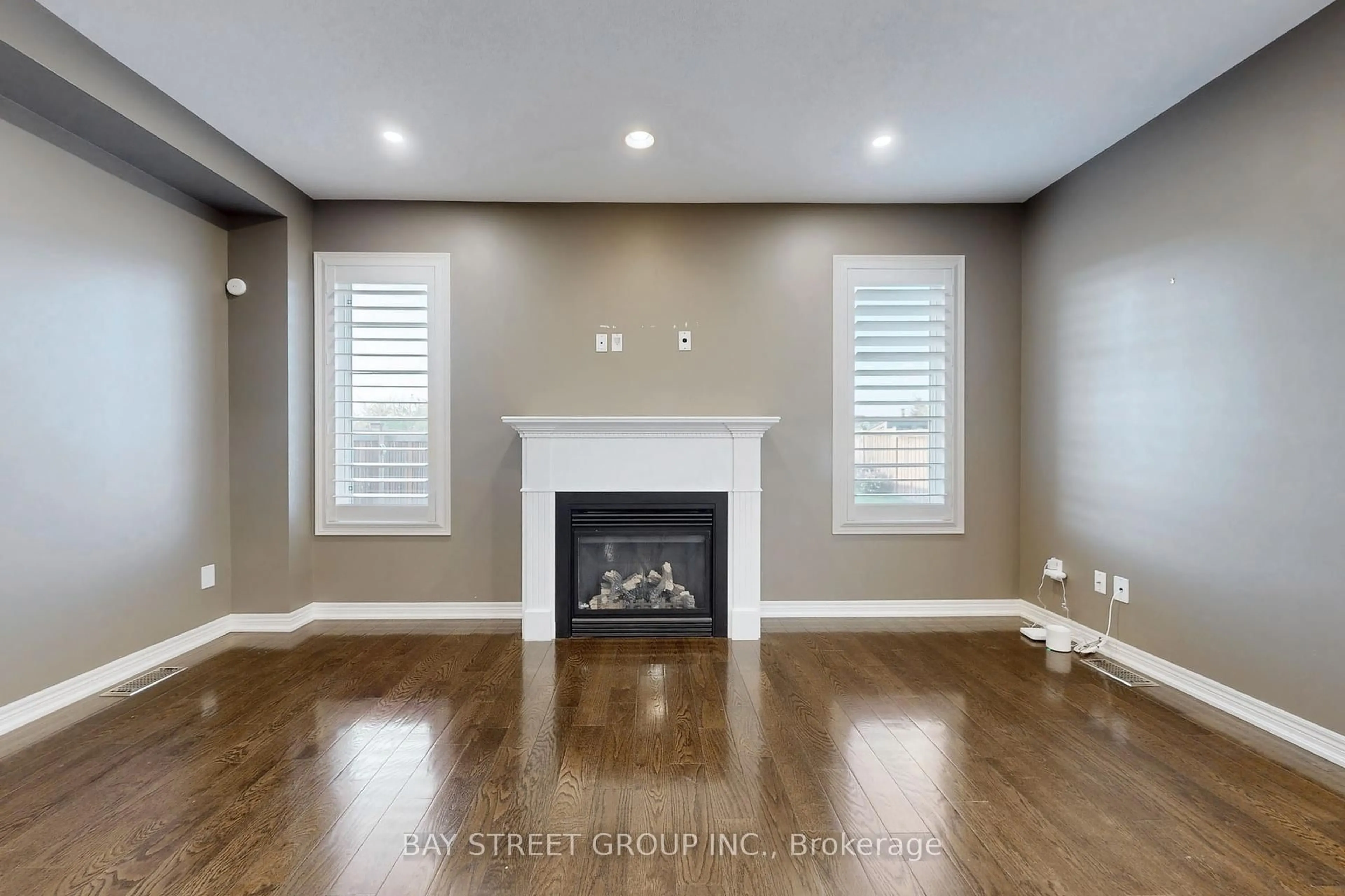 Living room with furniture, wood/laminate floor for 62 Whittington Dr, Hamilton Ontario L9K 0G8