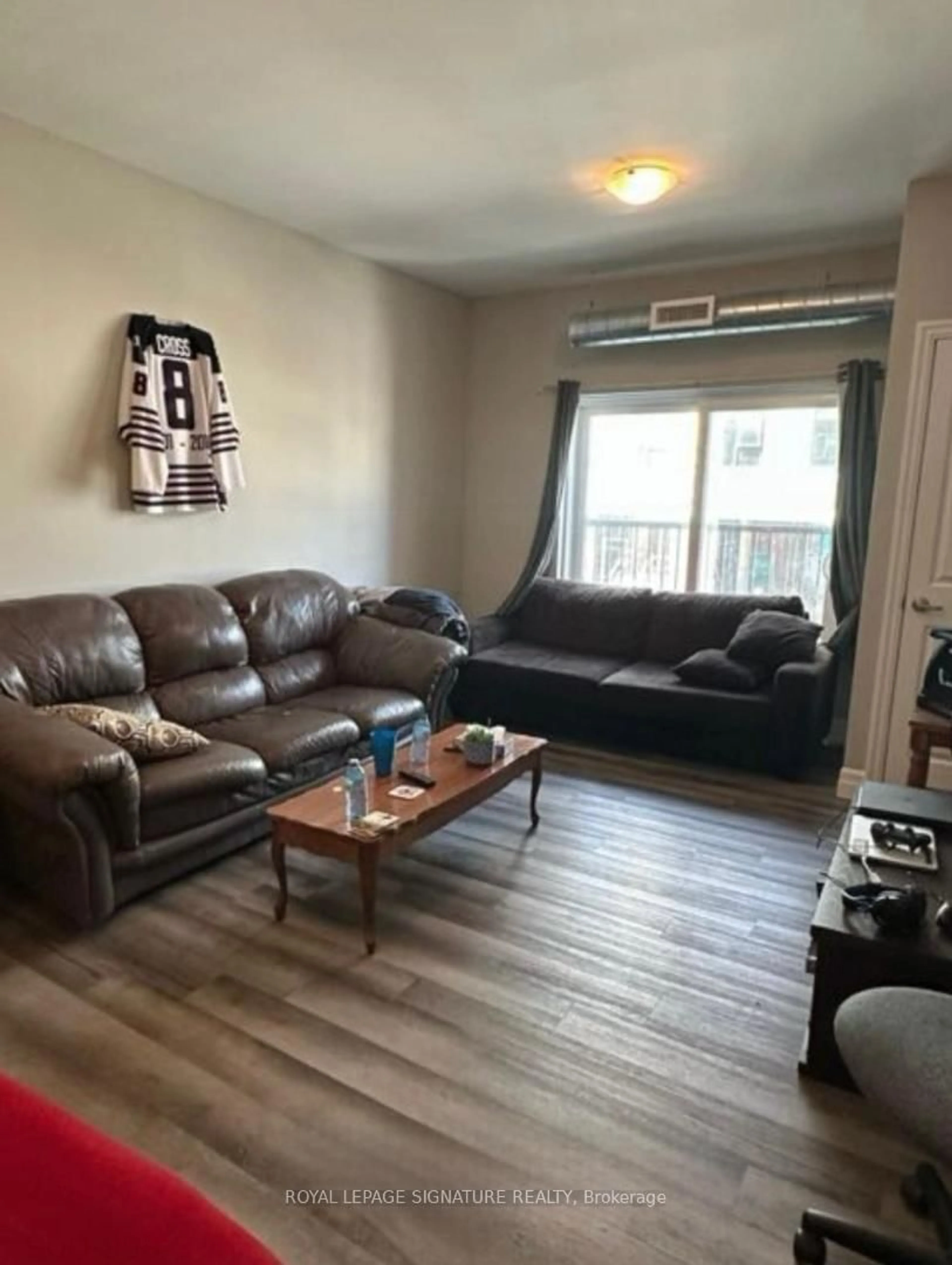 Living room with furniture, wood/laminate floor for 501 frontenec St #218, Kingston Ontario K7K 4L9