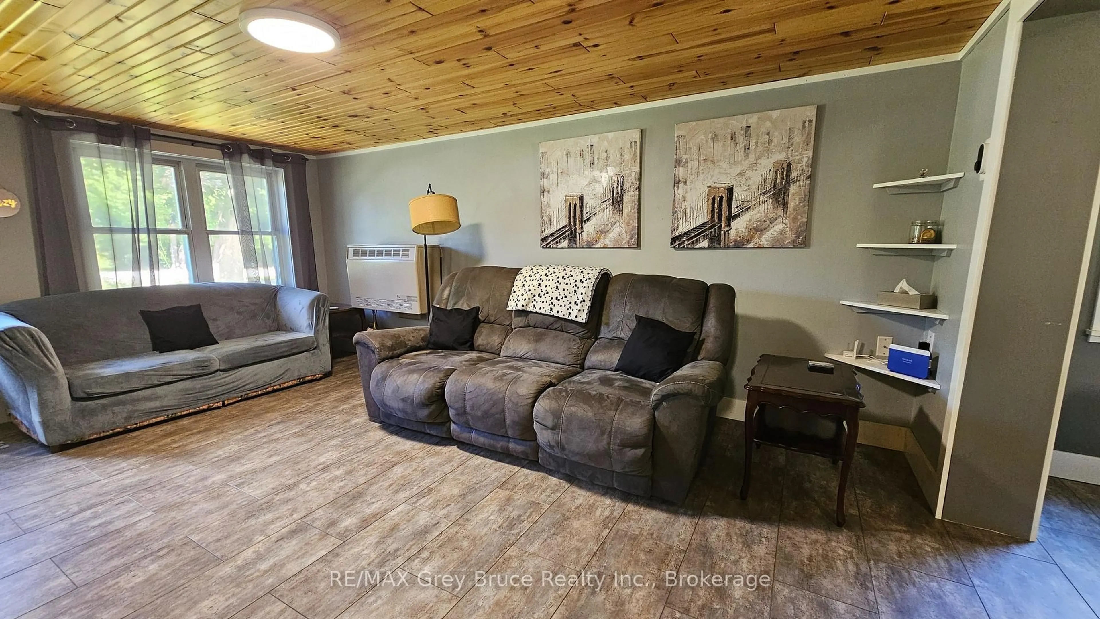 Living room with furniture, wood/laminate floor for 549 Stokes Bay Rd, Northern Bruce Peninsula Ontario N0H 1W0
