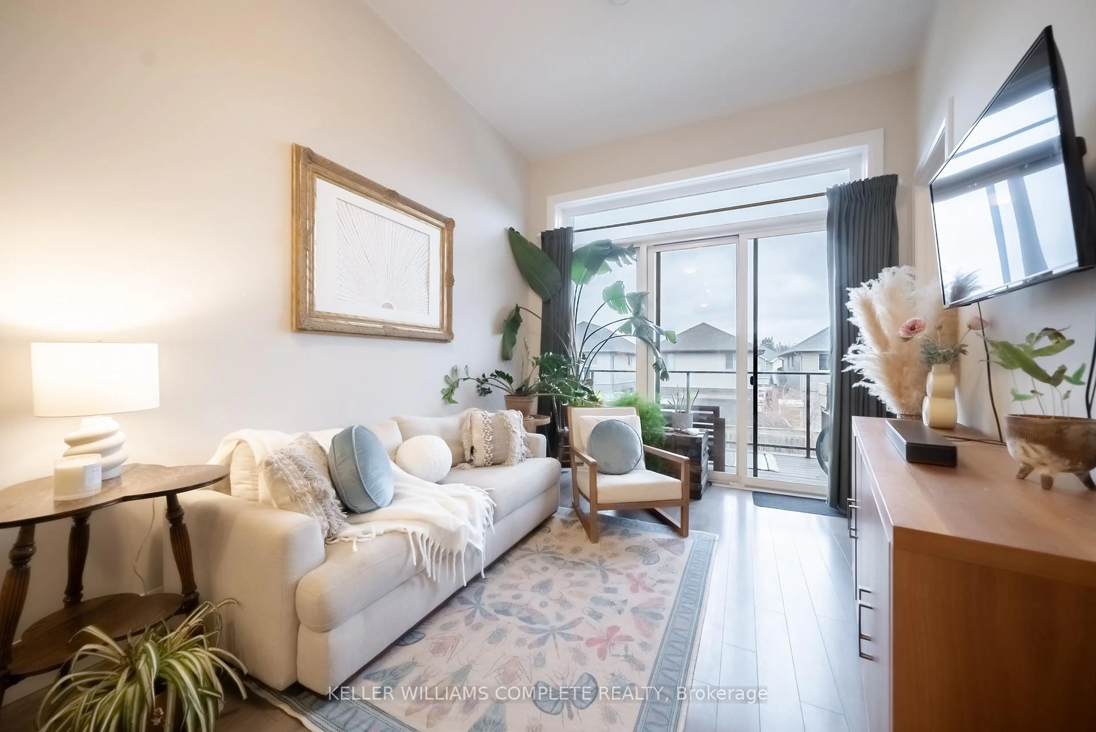 Living room with furniture, wood/laminate floor for 85 Morrell St #206, Brantford Ontario N3T 4J6