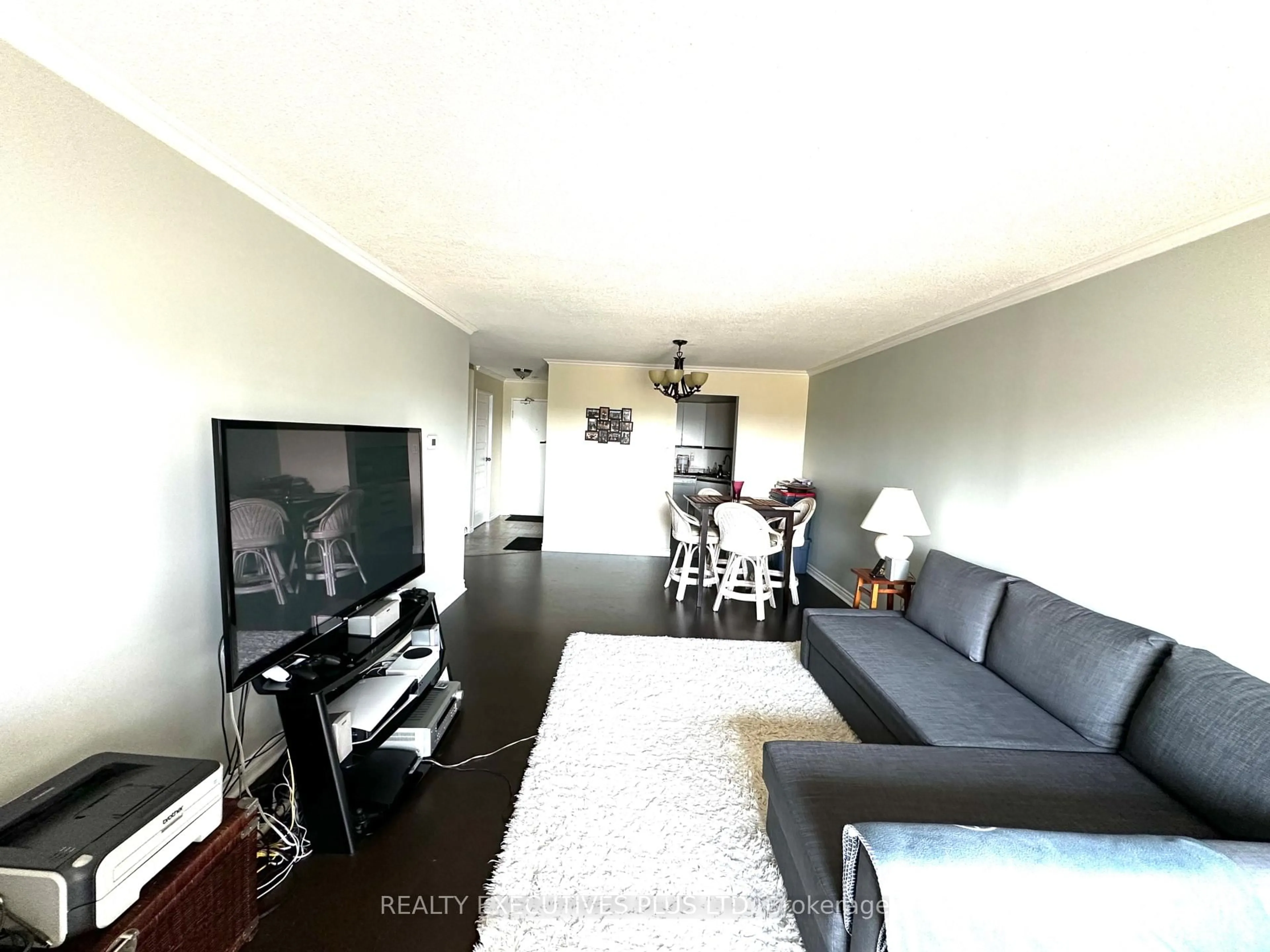 Living room with furniture, wood/laminate floor for 858 Commissioners Rd #806, London South Ontario N6C 5Y5
