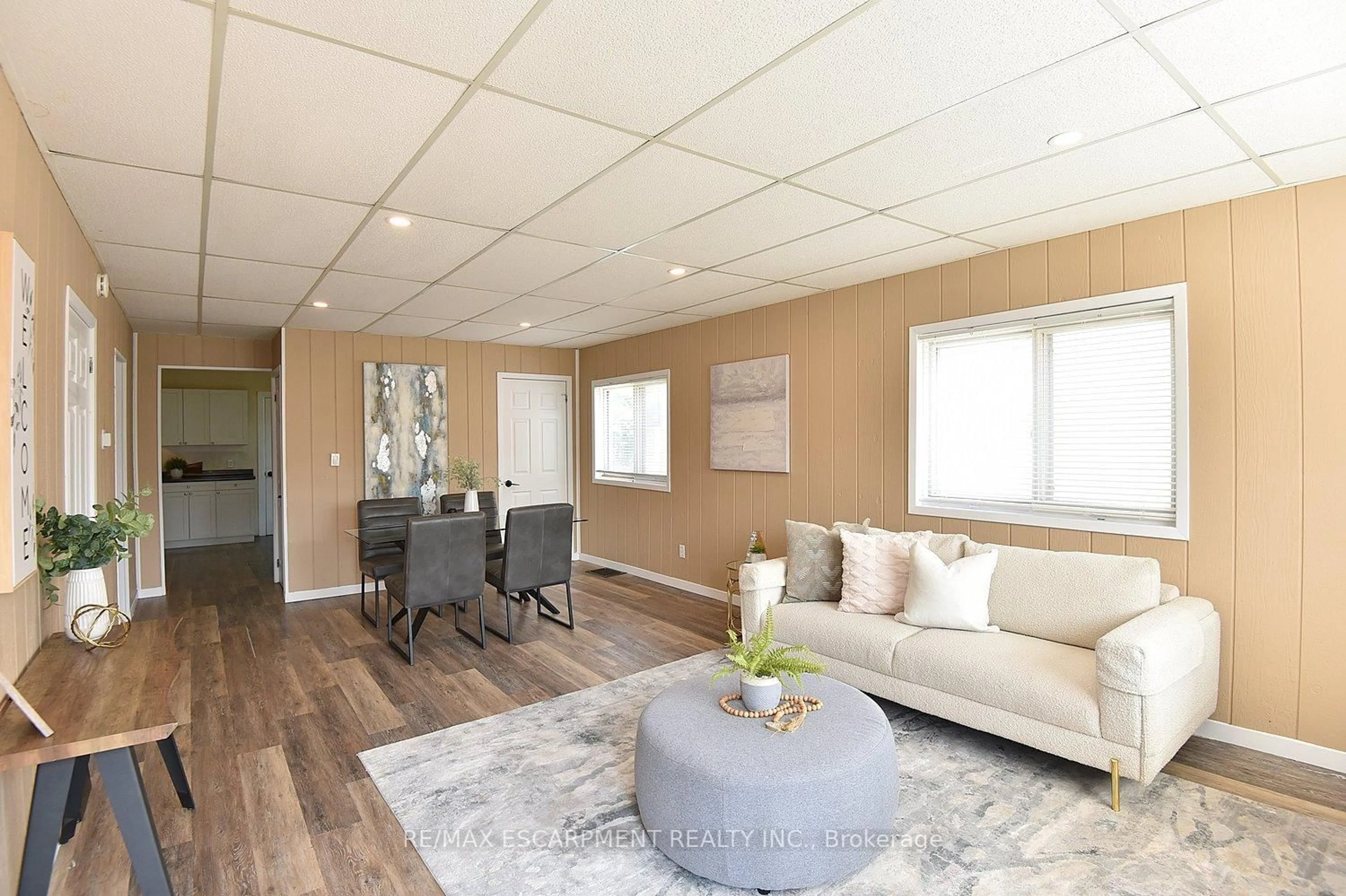 Living room with furniture, wood/laminate floor for 449 Mary St, Hamilton Ontario L8L 4X1