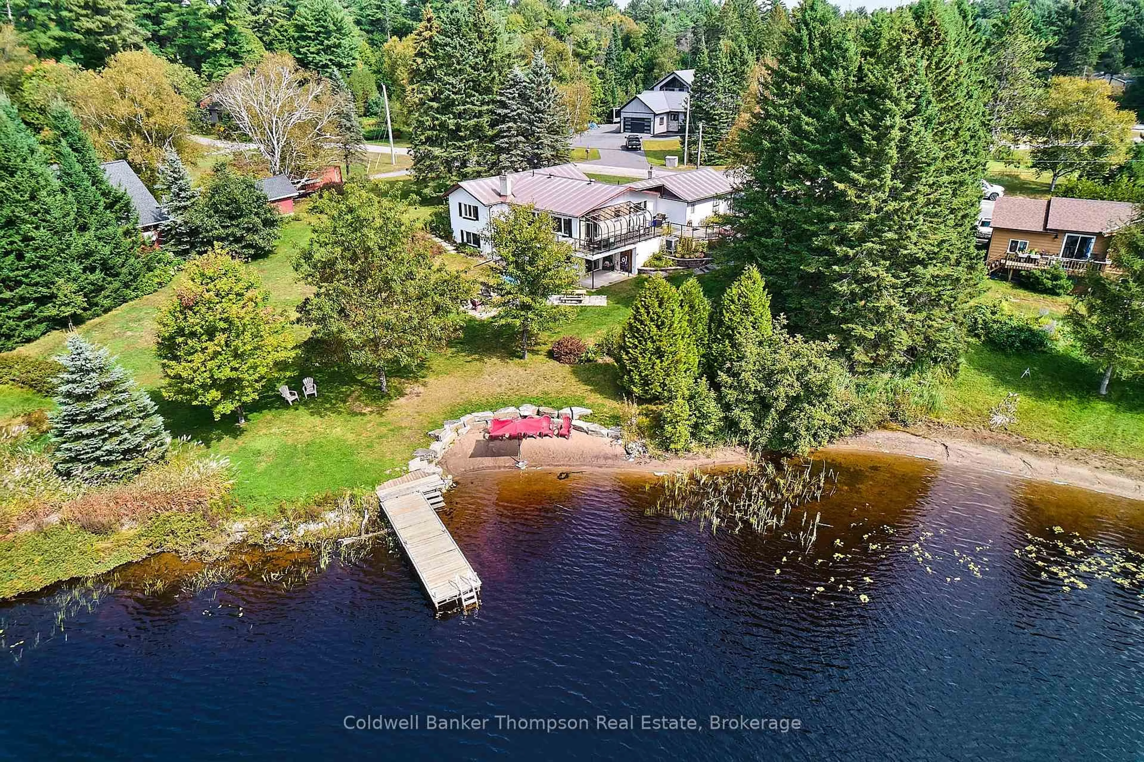 A pic from outside/outdoor area/front of a property/back of a property/a pic from drone, water/lake/river/ocean view for 32 Beach Rd, Huntsville Ontario P0B 1M0