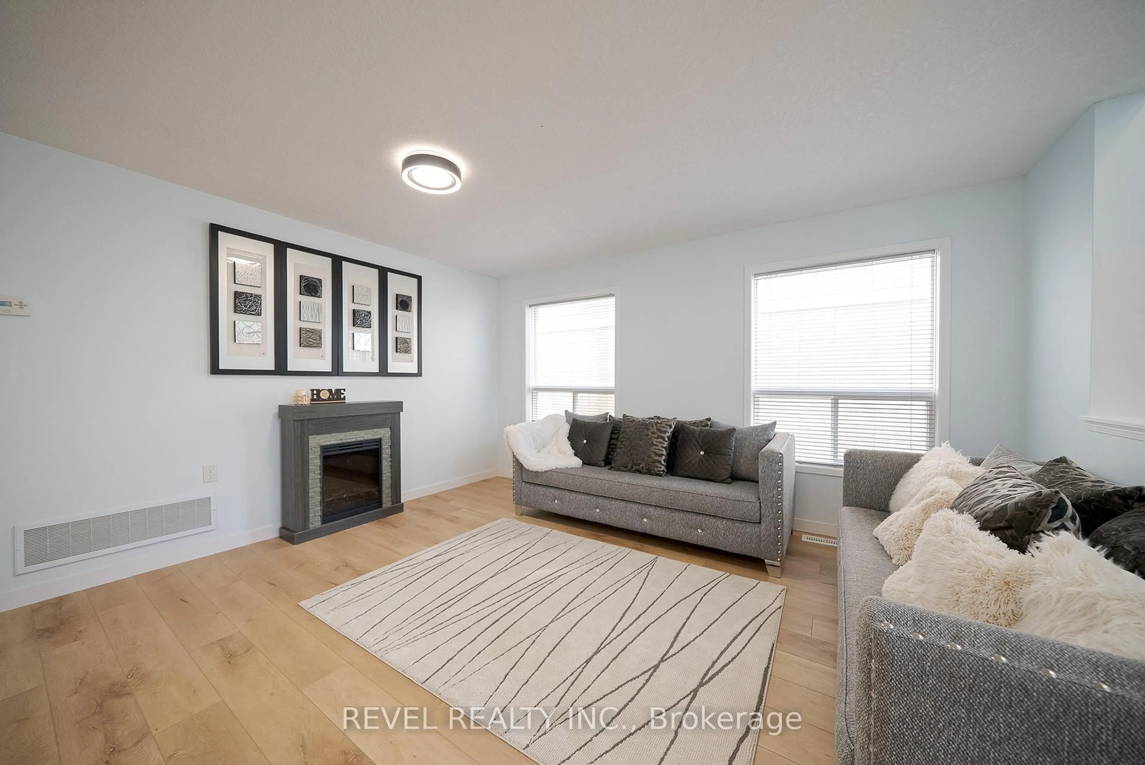 Living room with furniture, wood/laminate floor for 70 Blackburn Dr, Brantford Ontario N3T 6R9