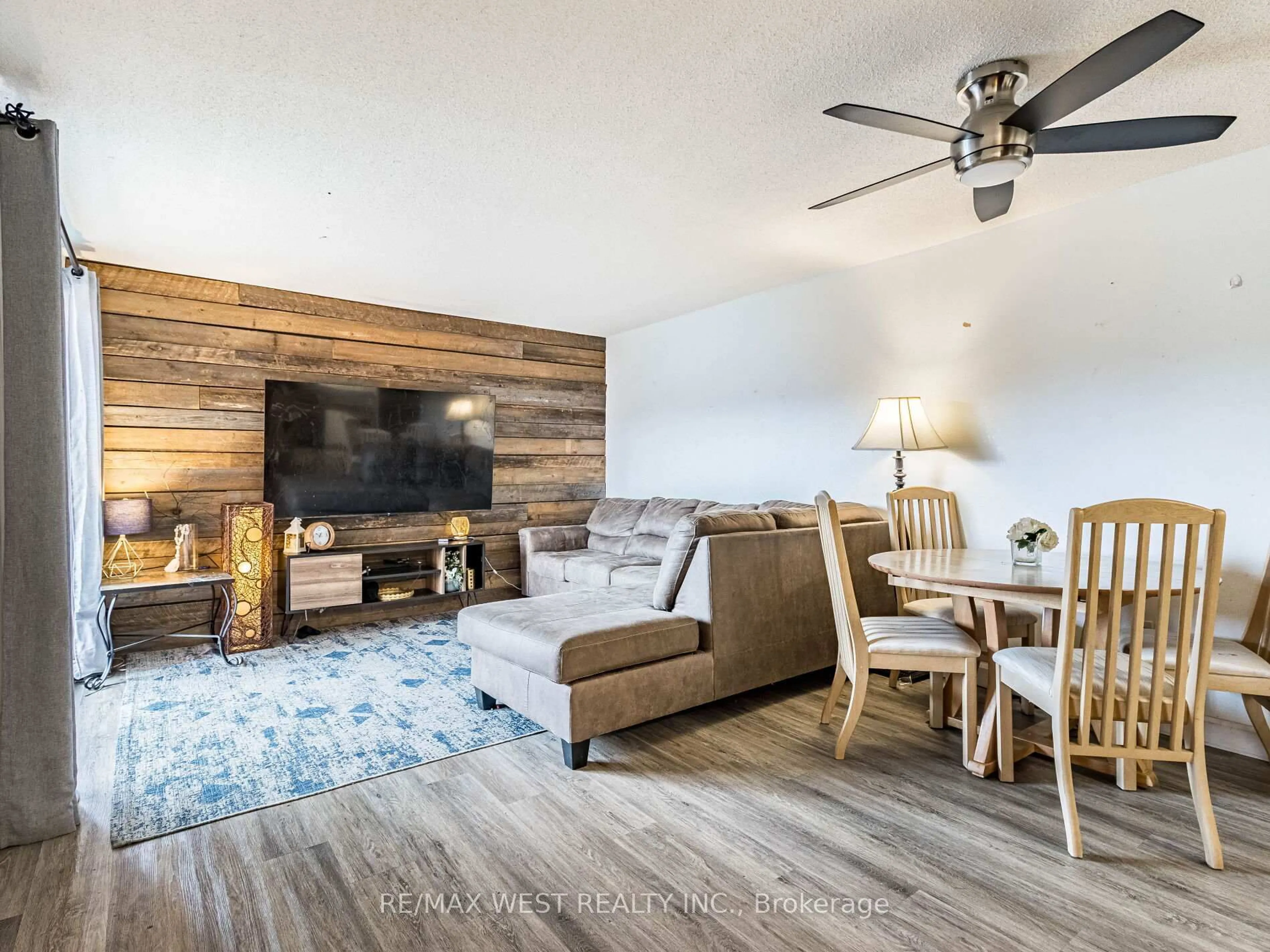 Living room with furniture, wood/laminate floor for 23 Main St #406, Hamilton Ontario L9H 2P7