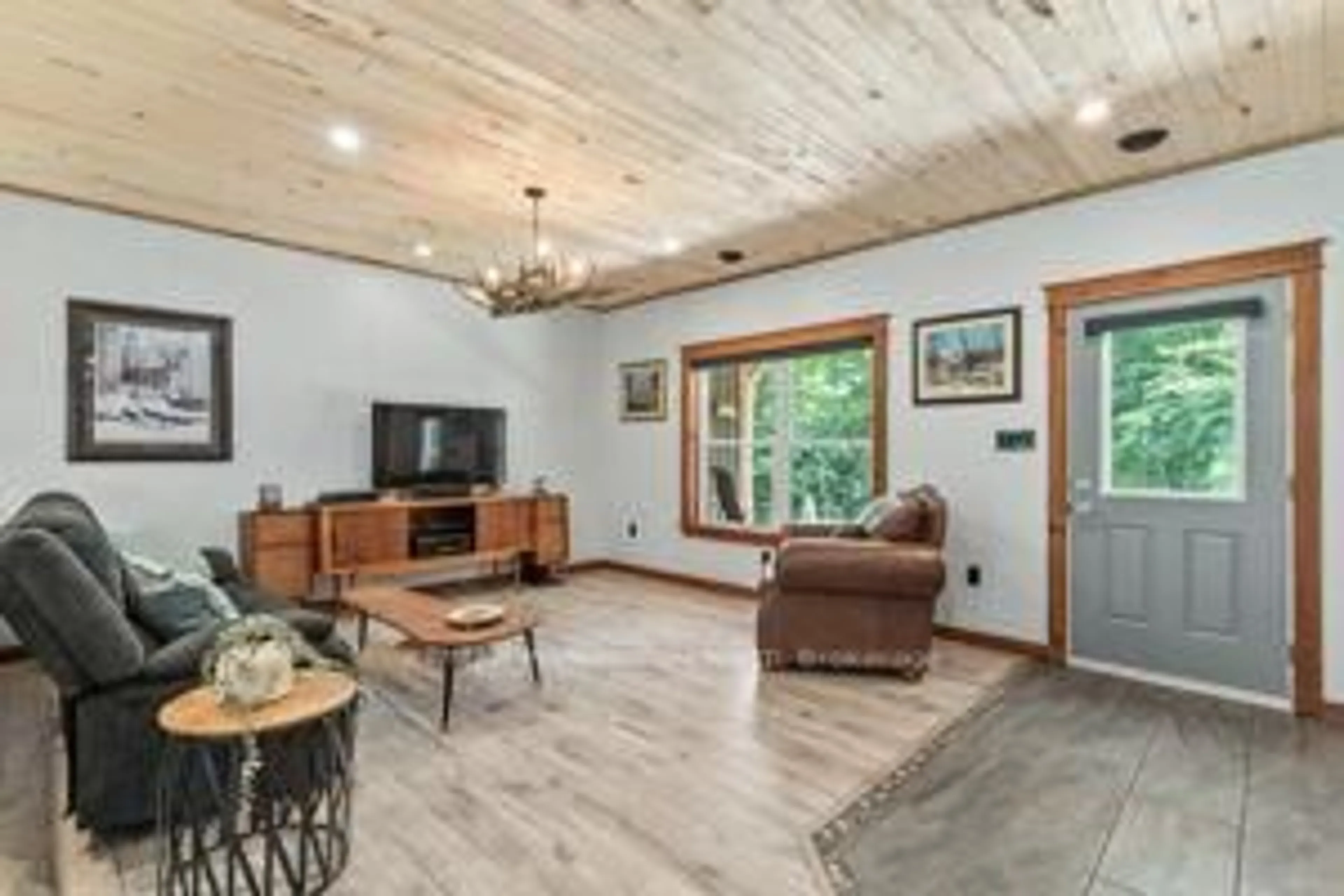 Living room with furniture, wood/laminate floor for 2430 Hadlington Rd, Highlands East Ontario K0L 3C0