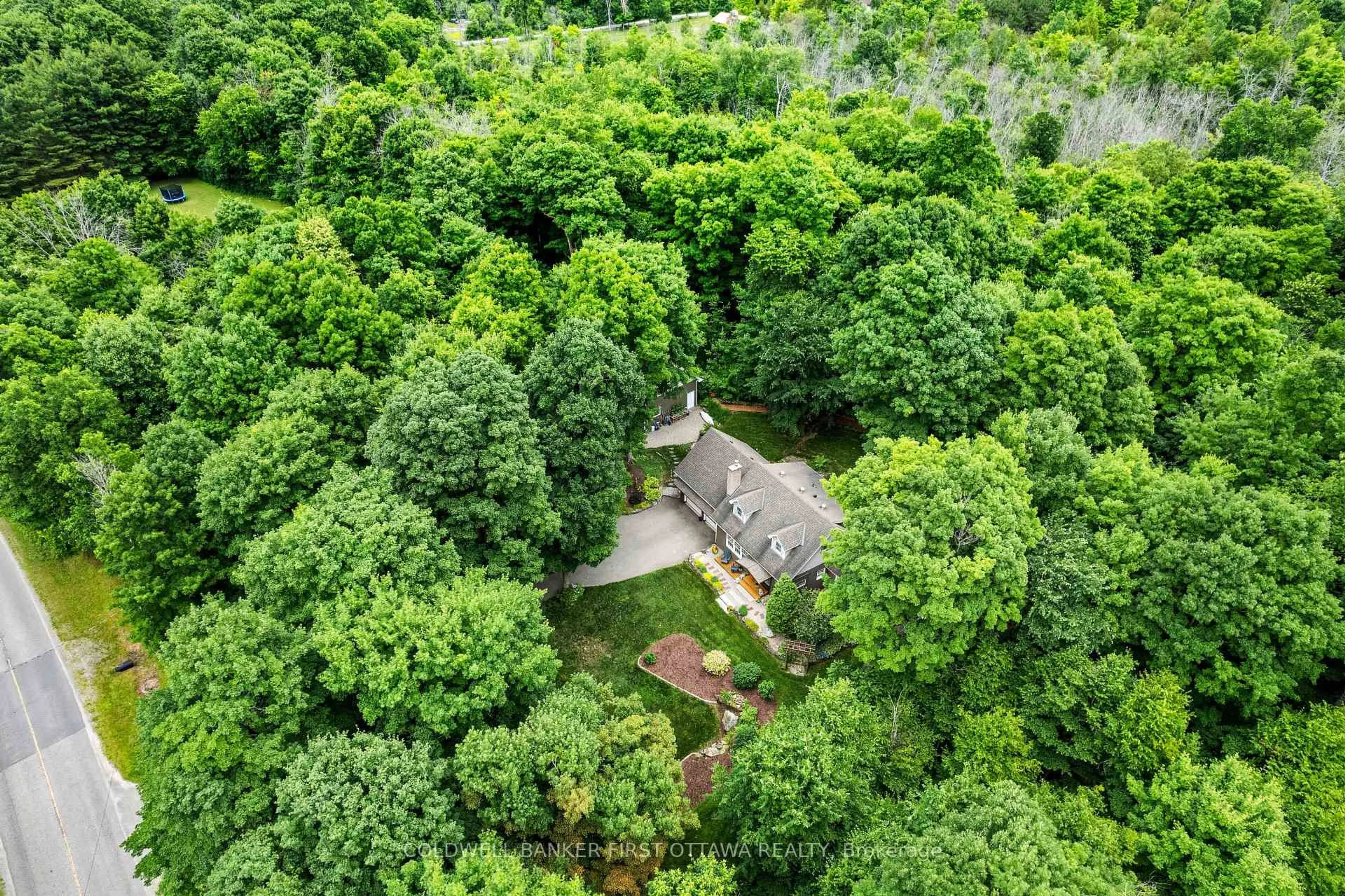 A pic from outside/outdoor area/front of a property/back of a property/a pic from drone, forest/trees view for 99 Old Kingston Rd, Rideau Lakes Ontario K0G 1L0