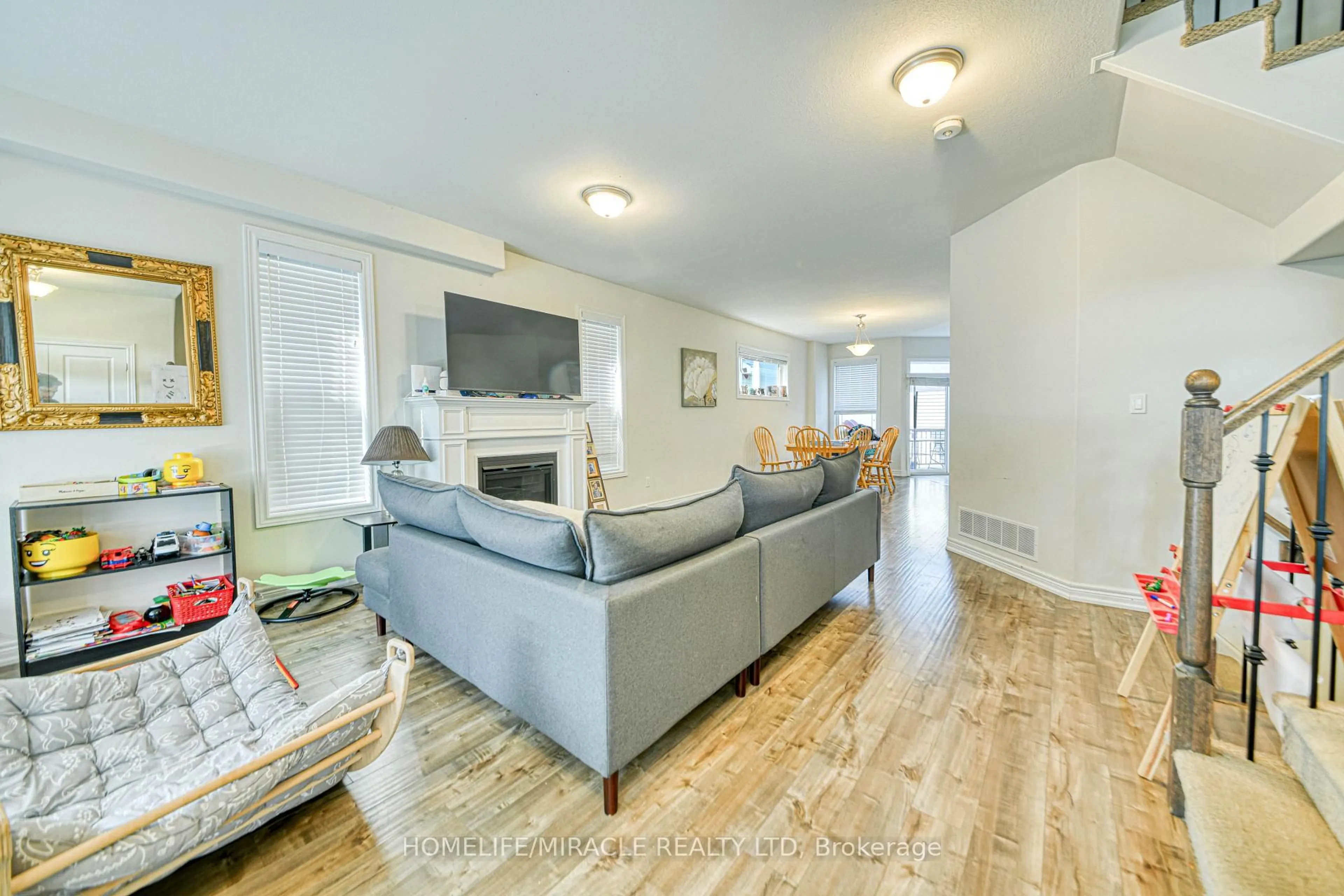 Living room with furniture, wood/laminate floor for 56 Flitton Ave, Peterborough North Ontario K9H 0G5