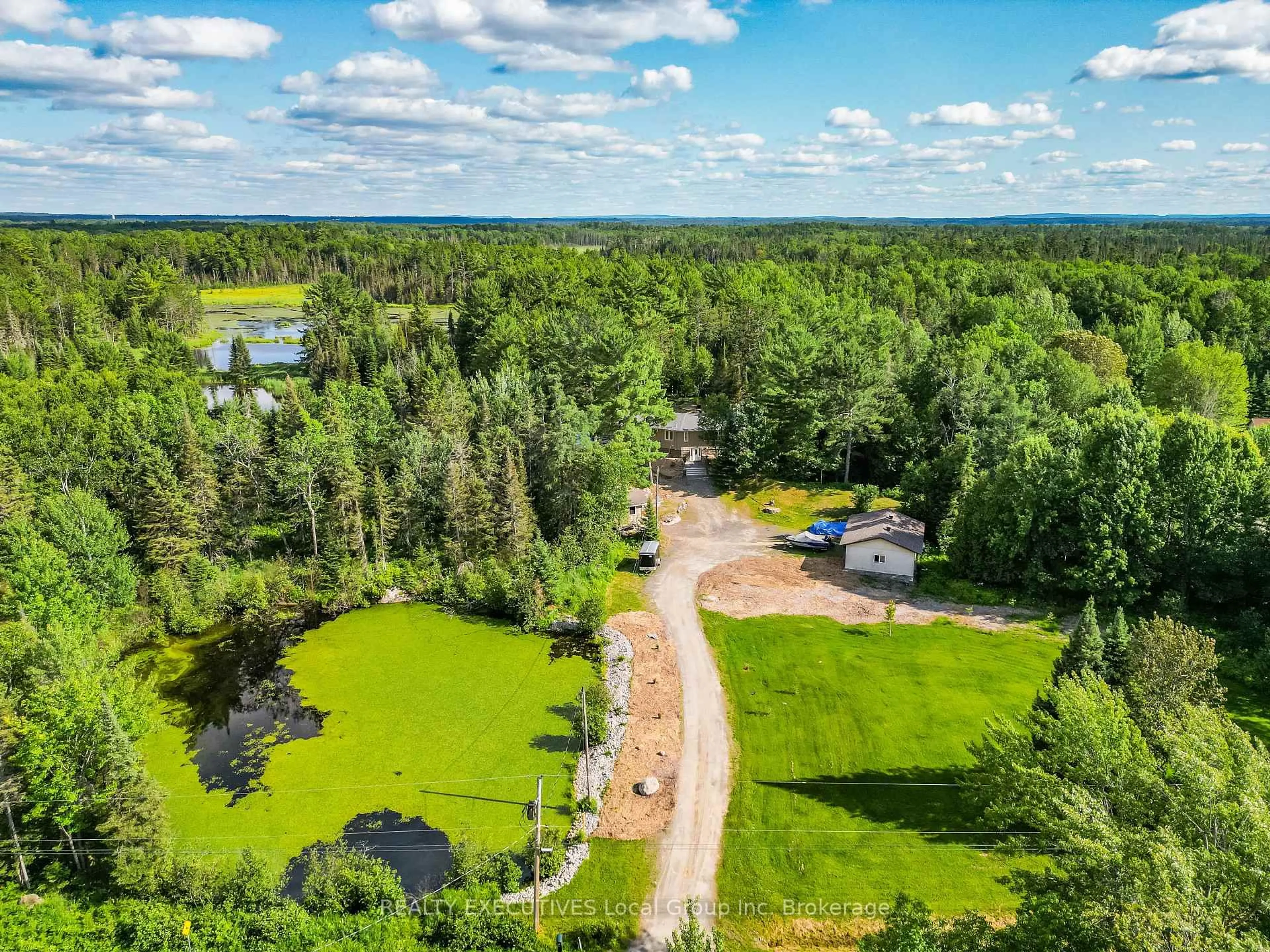 A pic from outside/outdoor area/front of a property/back of a property/a pic from drone, forest/trees view for 520 Riverbend Rd, North Bay Ontario P1B 8Z4