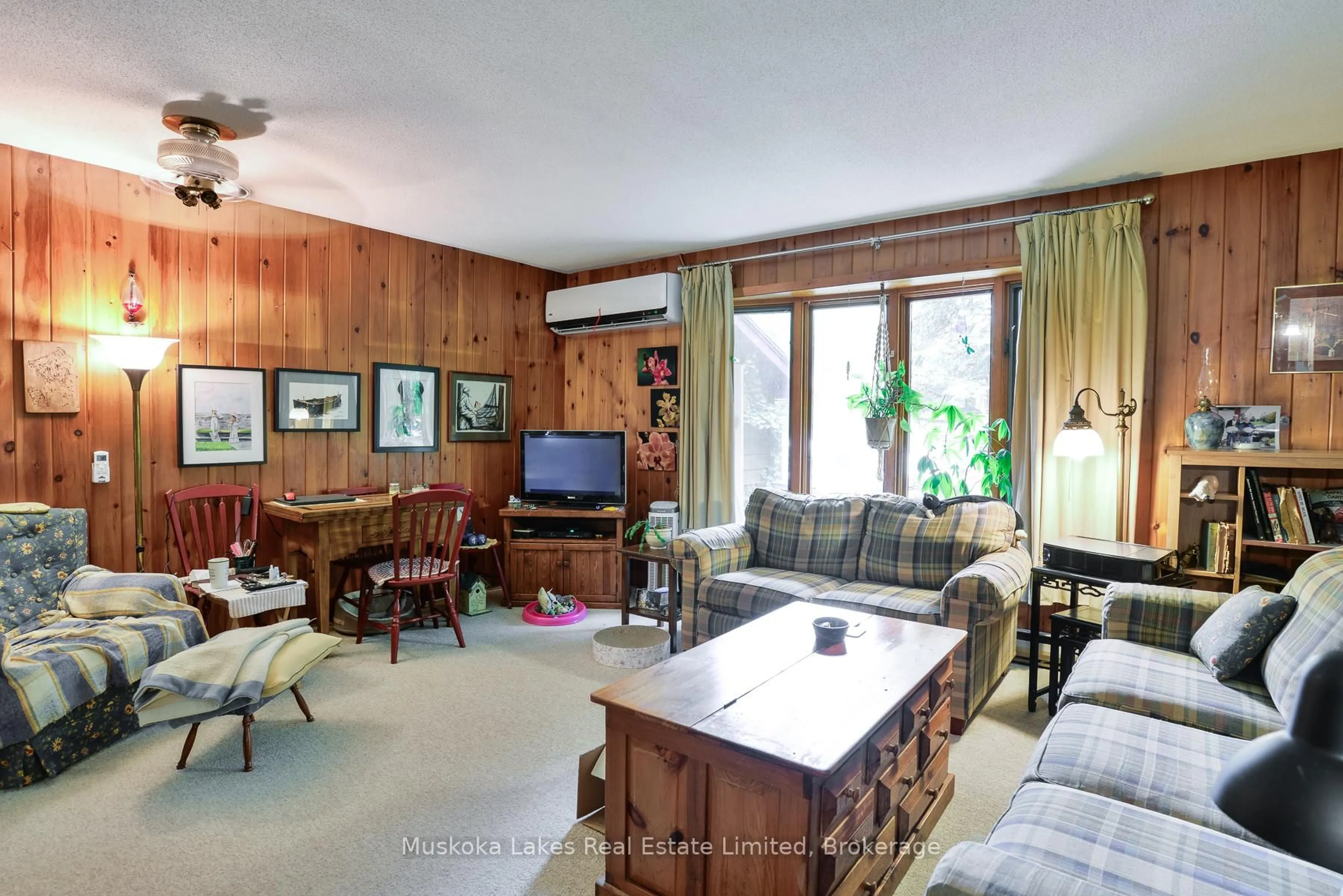 Living room with furniture, wood/laminate floor for 2065 Peninsula Rd, Muskoka Lakes Ontario P0B 1G0