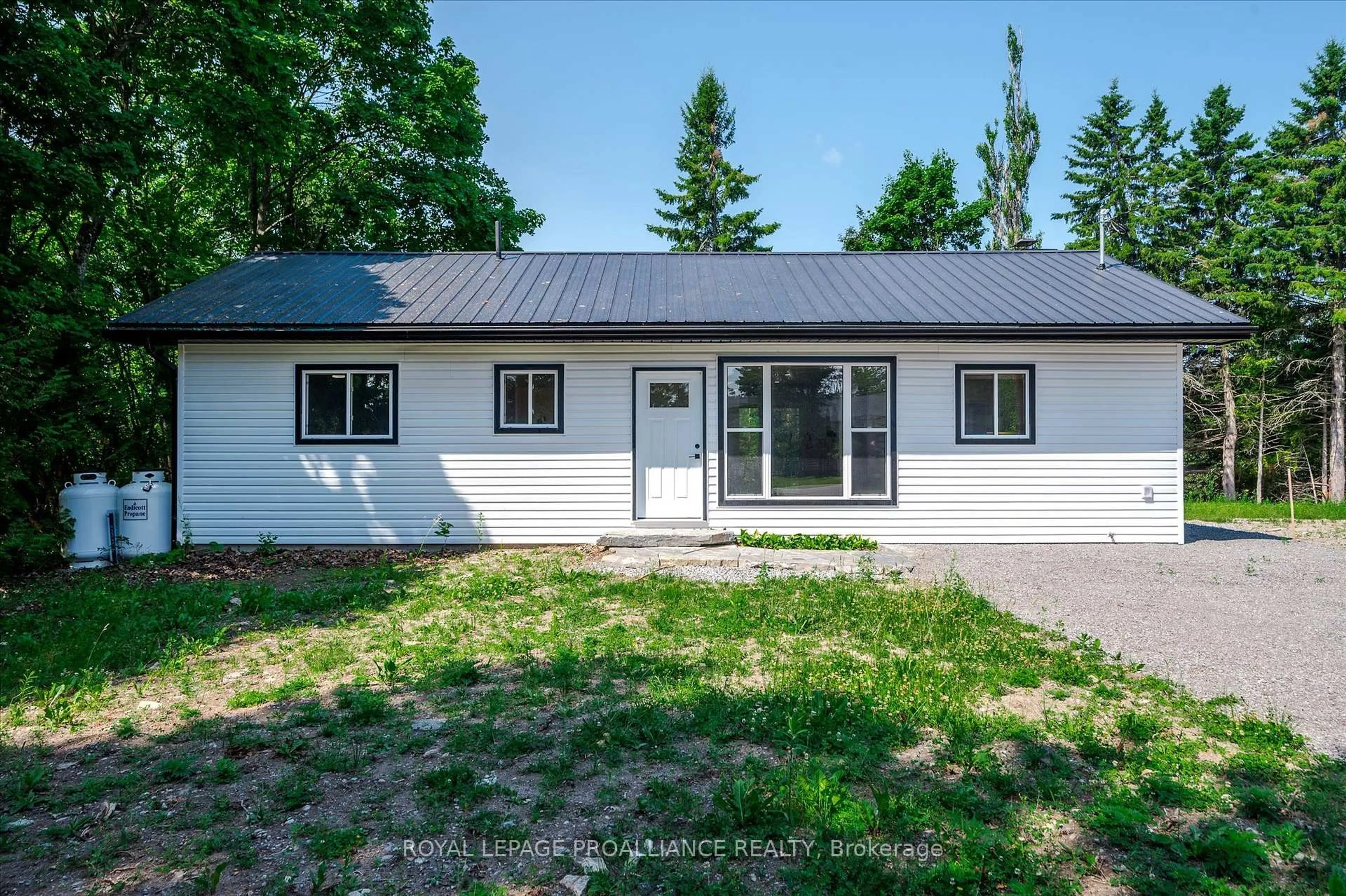 Home with vinyl exterior material, street for 100 Reid St, Kawartha Lakes Ontario K0M 1A0