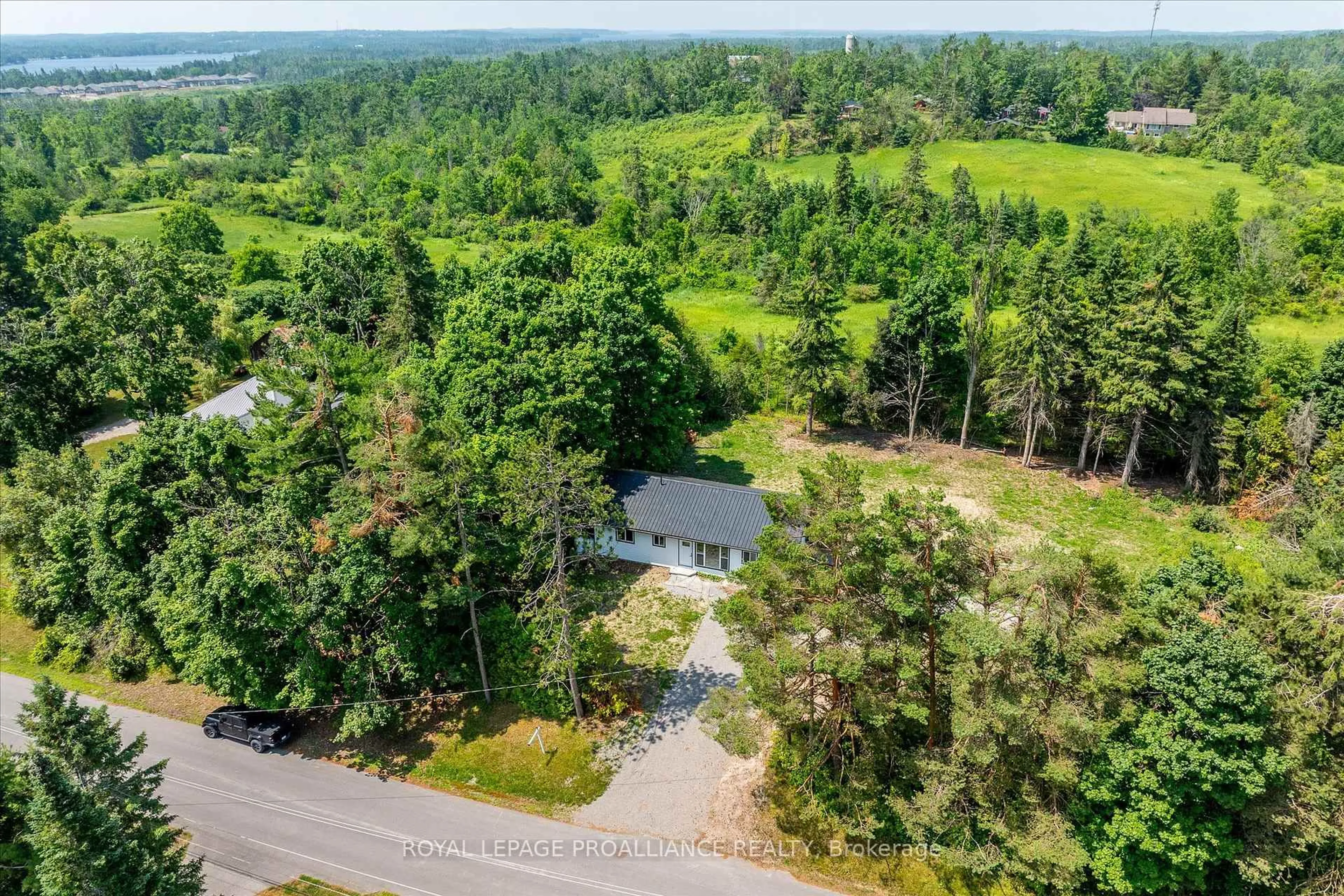 A pic from outside/outdoor area/front of a property/back of a property/a pic from drone, forest/trees view for 100 Reid St, Kawartha Lakes Ontario K0M 1A0