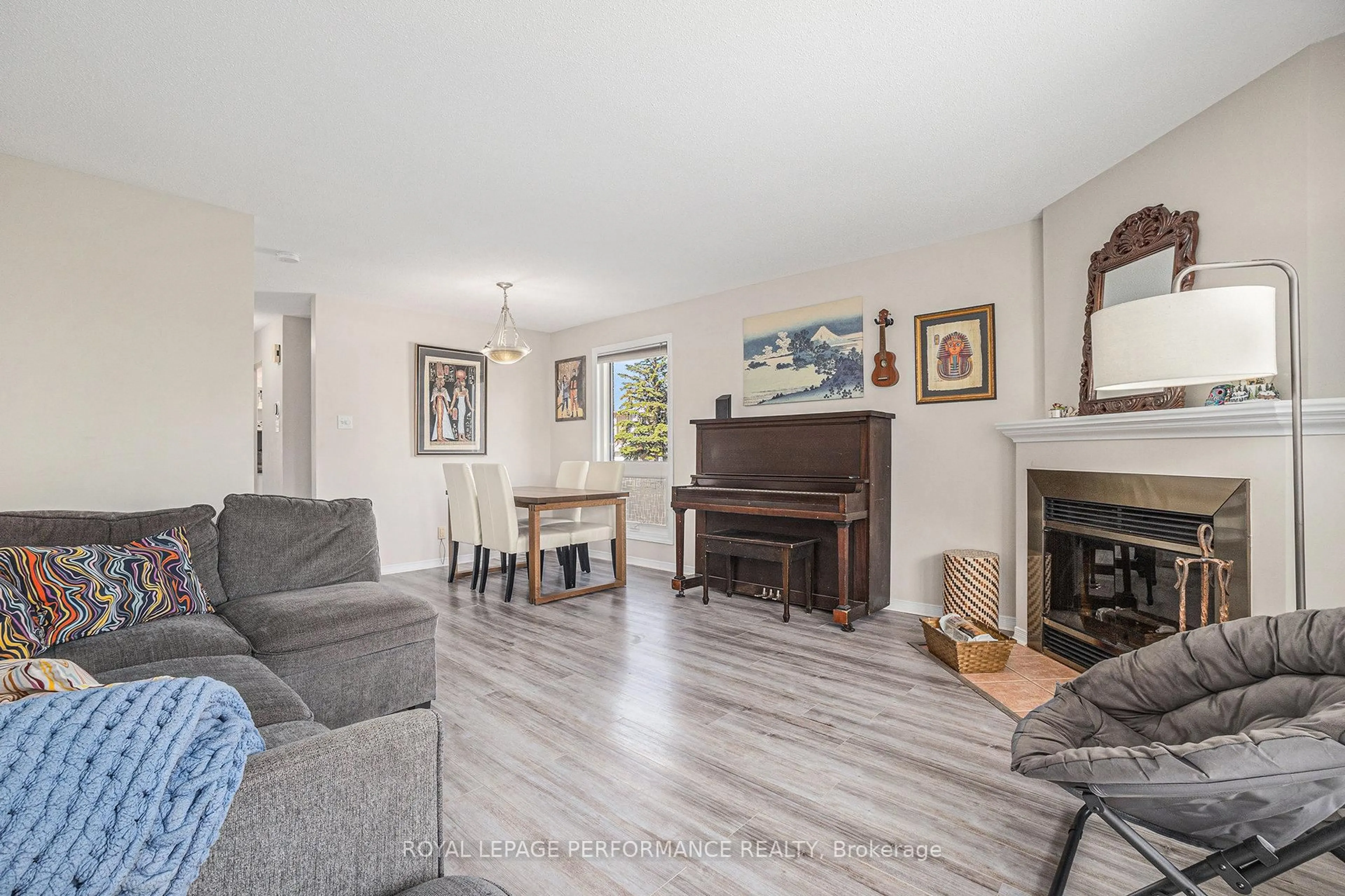 Living room with furniture, wood/laminate floor for 6074 Red Willow Dr, Ottawa Ontario K1C 7J5