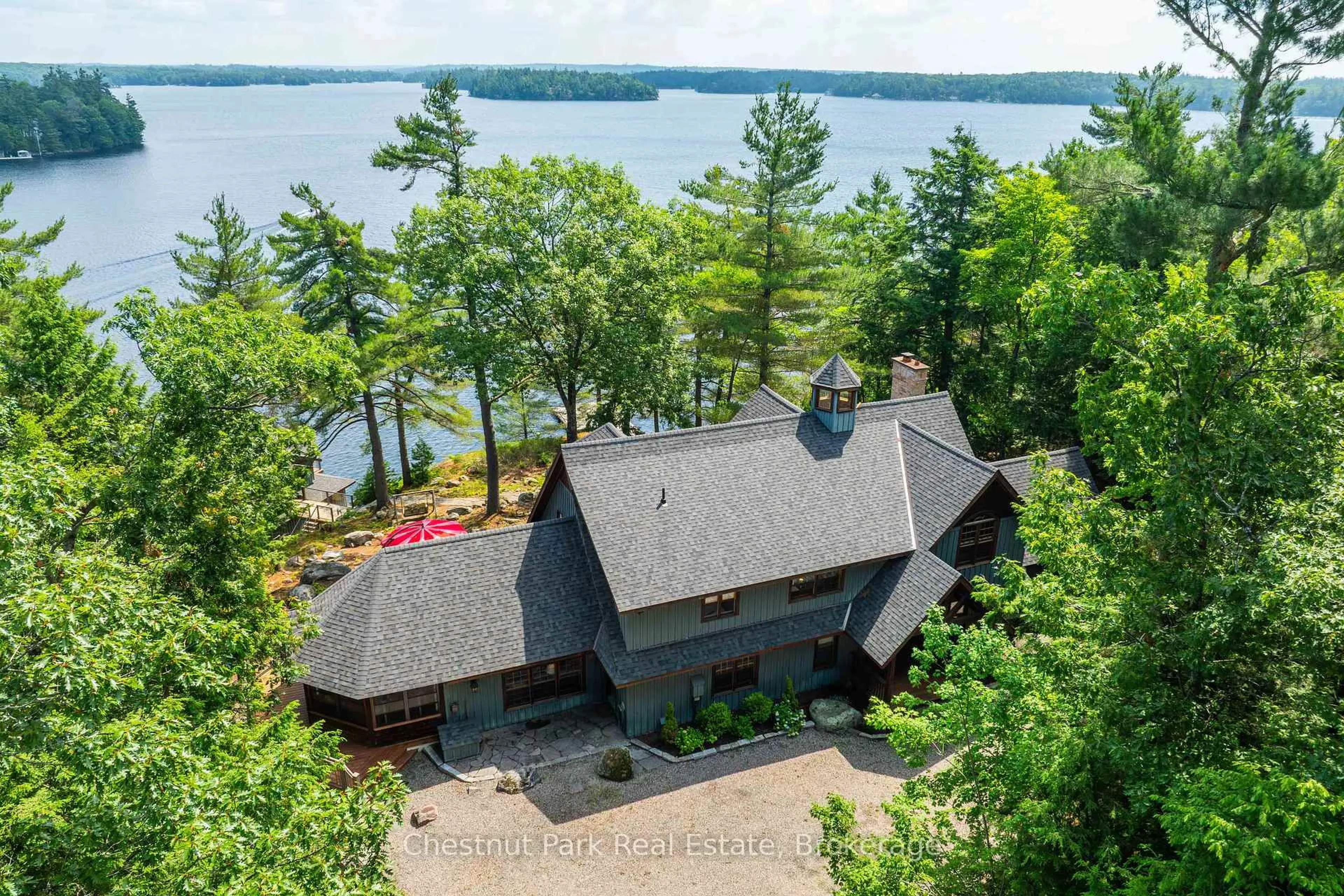 A pic from outside/outdoor area/front of a property/back of a property/a pic from drone, water/lake/river/ocean view for 1341 Innisfree Rd, Muskoka Lakes Ontario P0B 1J0