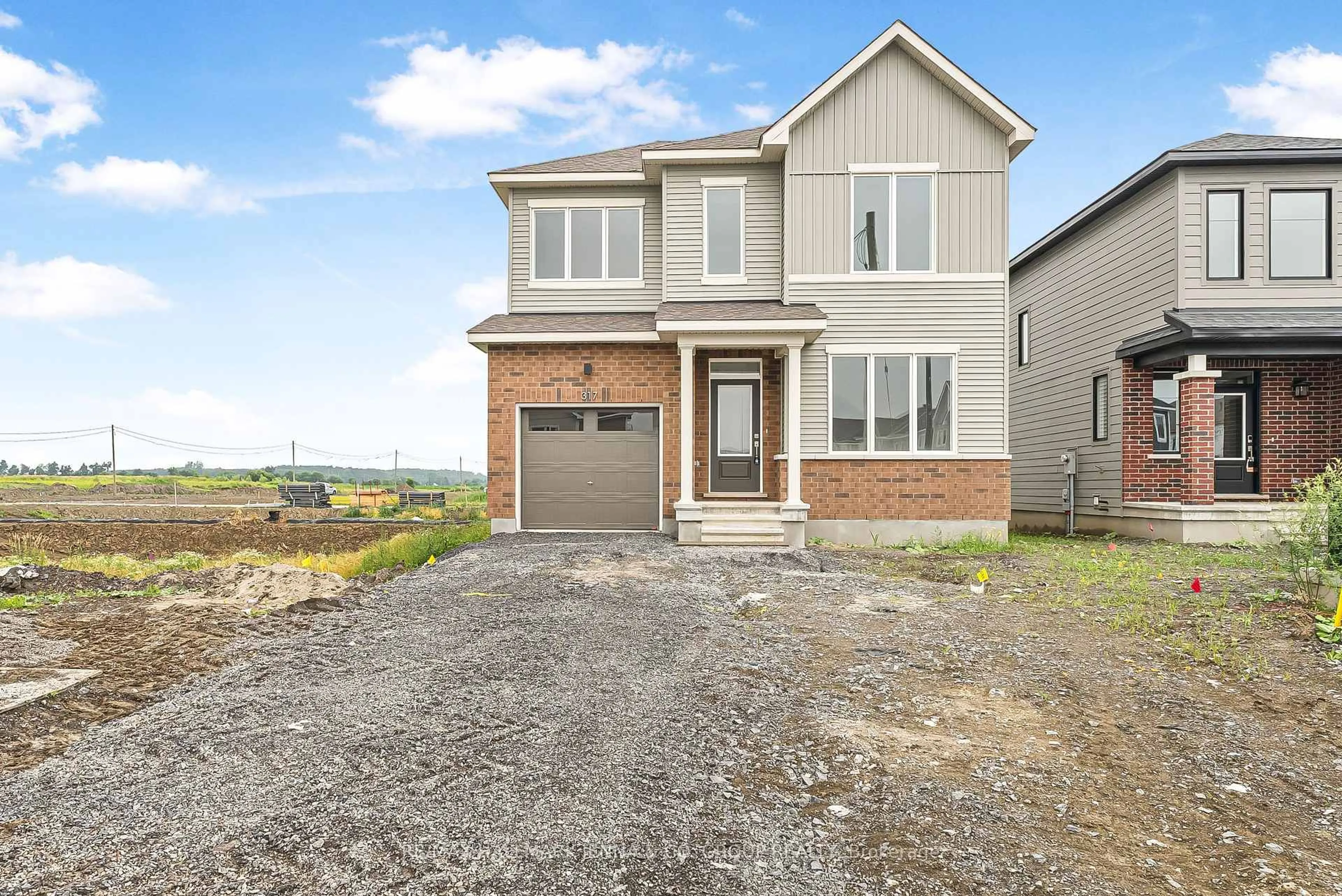 Home with brick exterior material, street for 317 Cantering Dr, Stittsville Ontario K0A 2Z2