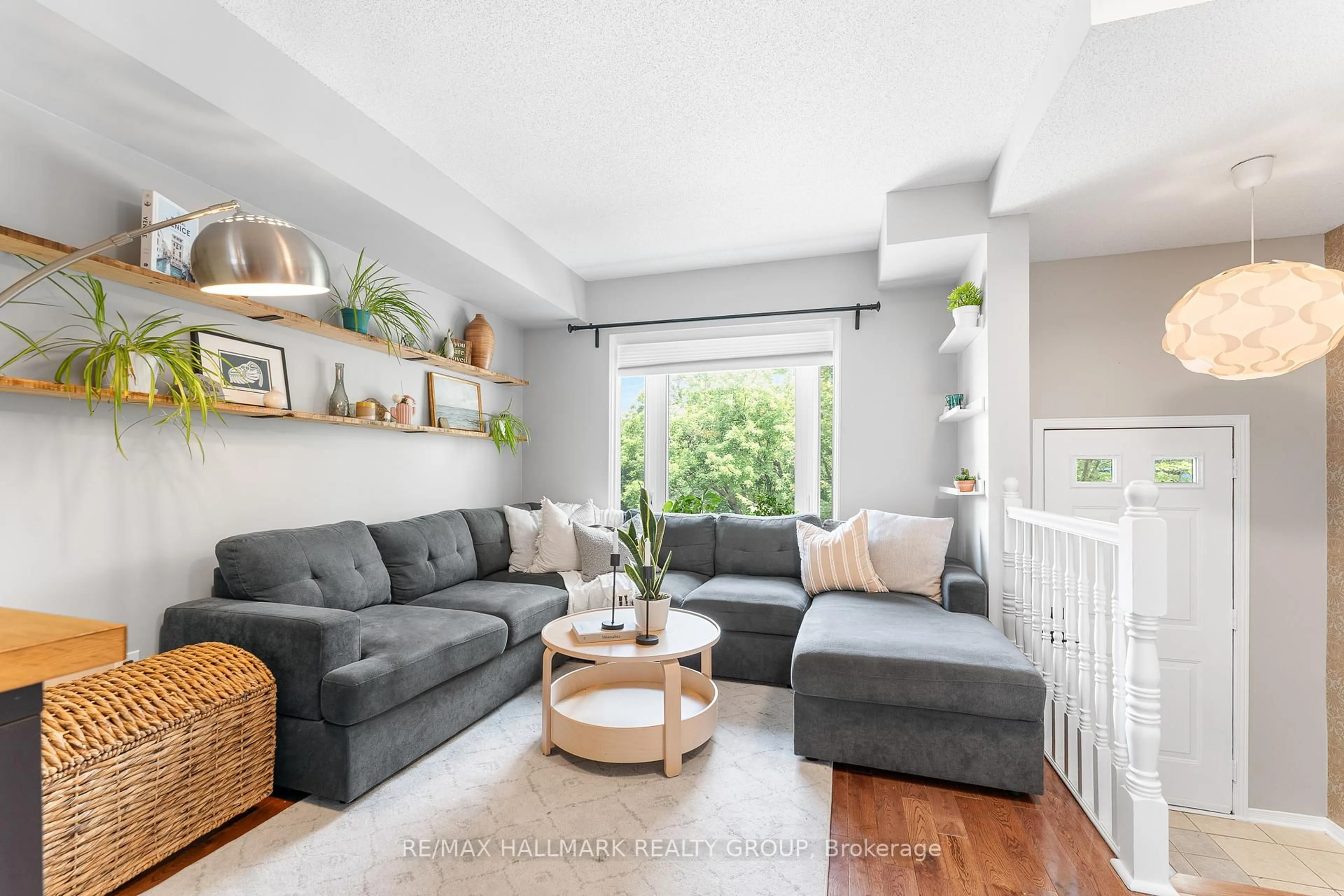 Living room with furniture, wood/laminate floor for 42 Hintonburg Pl, Ottawa Ontario K1Y 4W6