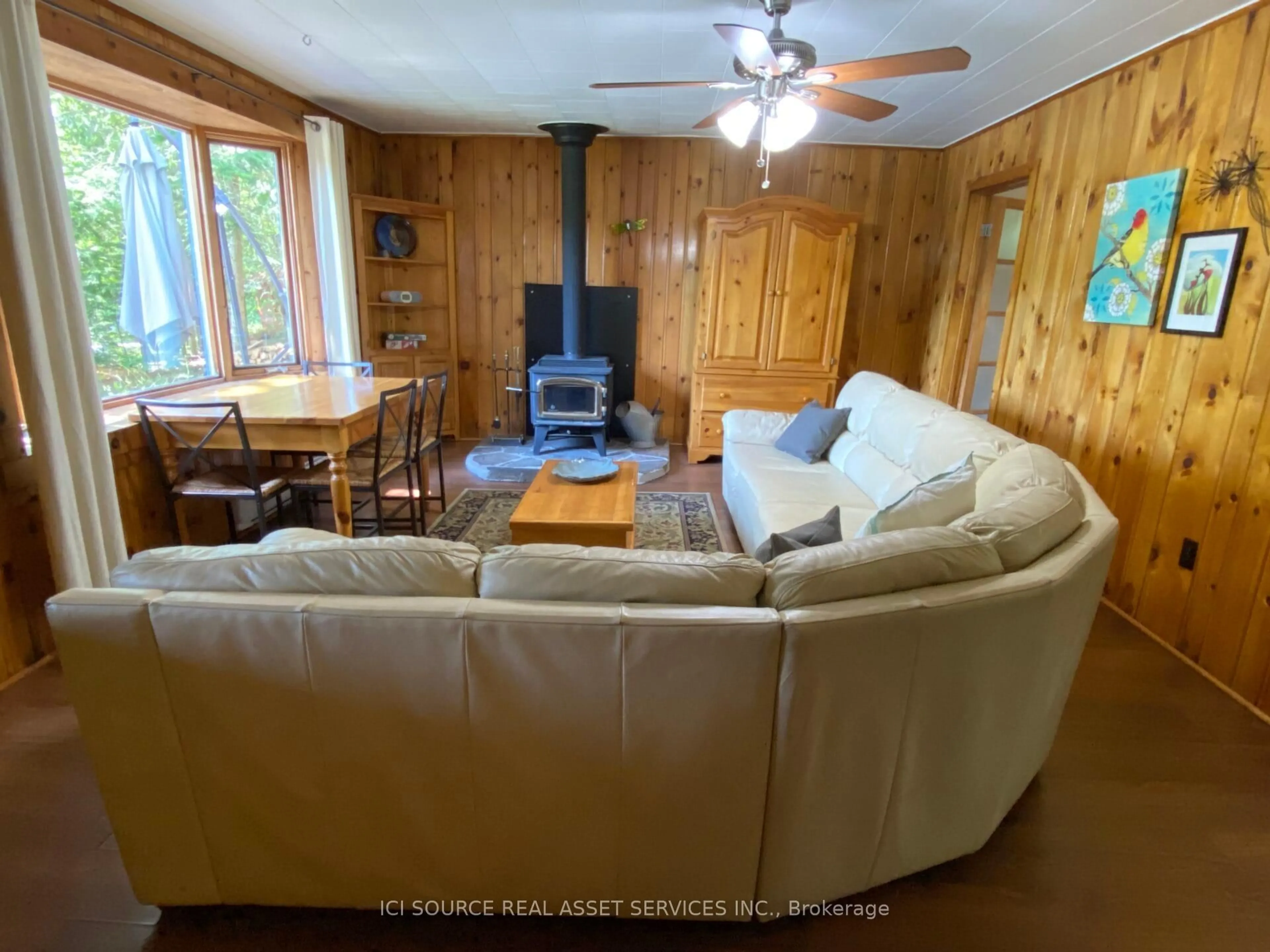 Living room with furniture, wood/laminate floor for 1054 Keysbury Dr, Algonquin Highlands Ontario P0A 1H0