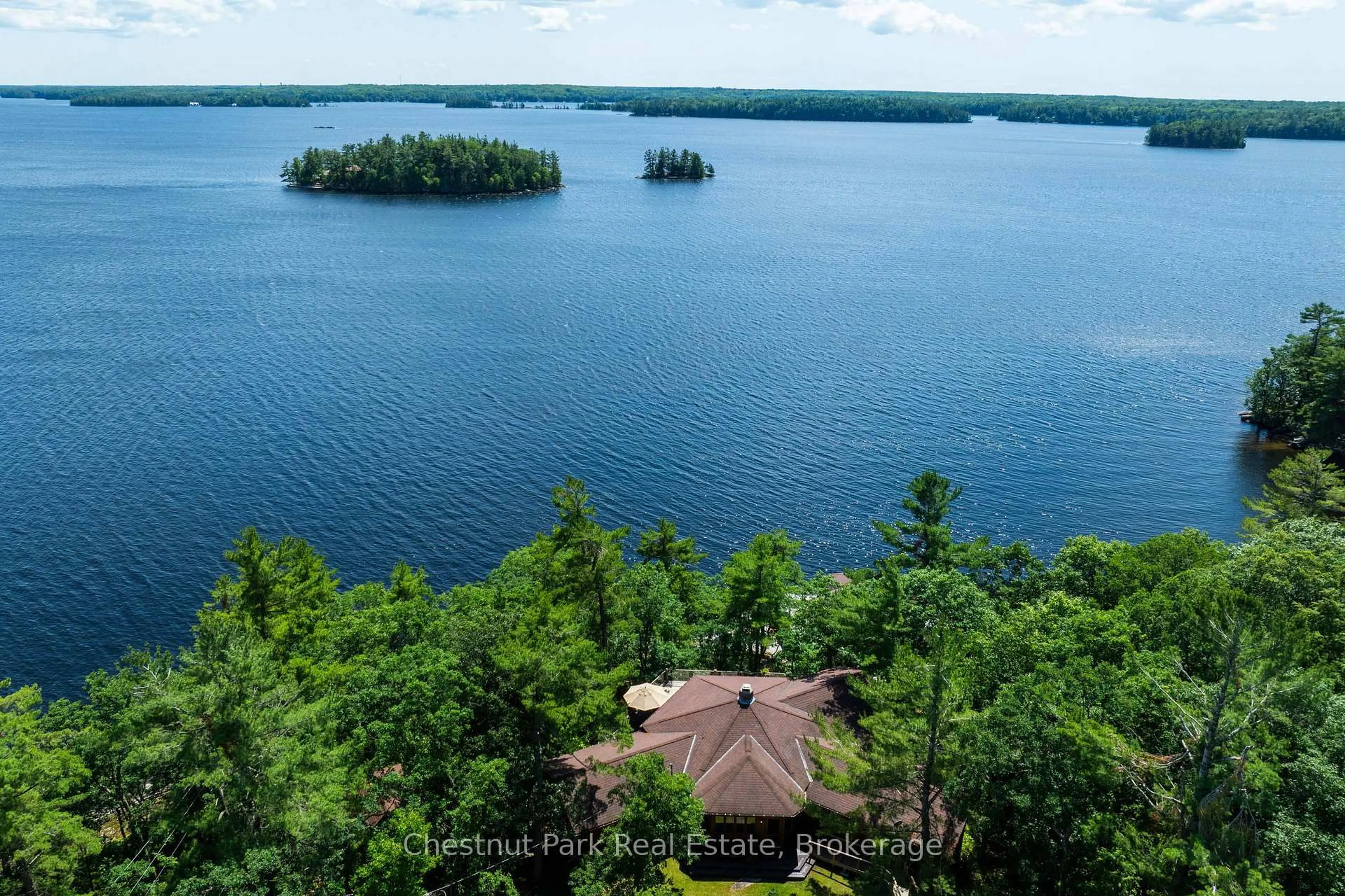 A pic from outside/outdoor area/front of a property/back of a property/a pic from drone, water/lake/river/ocean view for 2143 Muskoka Rd 118w #1, Muskoka Lakes Ontario P1L 1W8