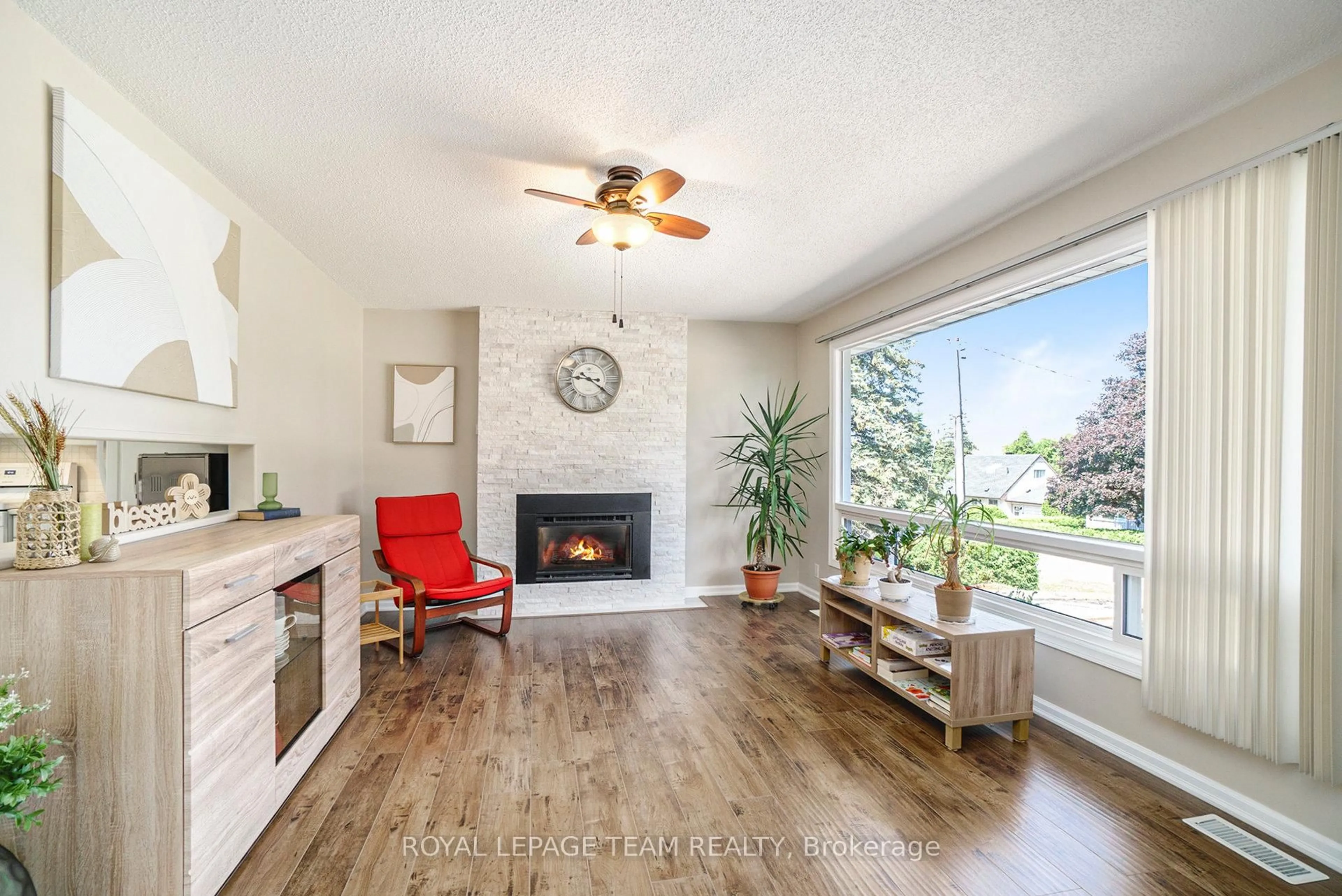 Living room with furniture, wood/laminate floor for 6870 Edgar Brault St, Orleans Ontario K1C 1L7