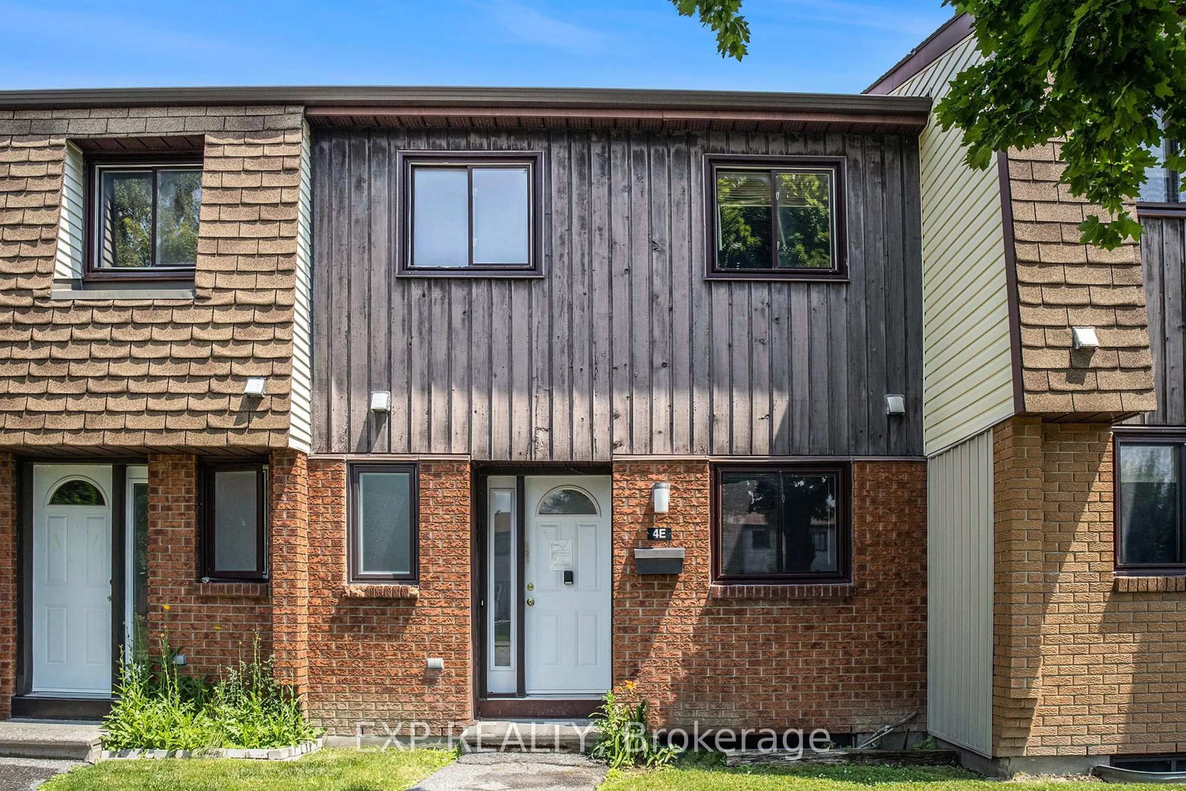 Home with brick exterior material, street for 39 Woodvale Green #4E, Ottawa Ontario K2G 4G8