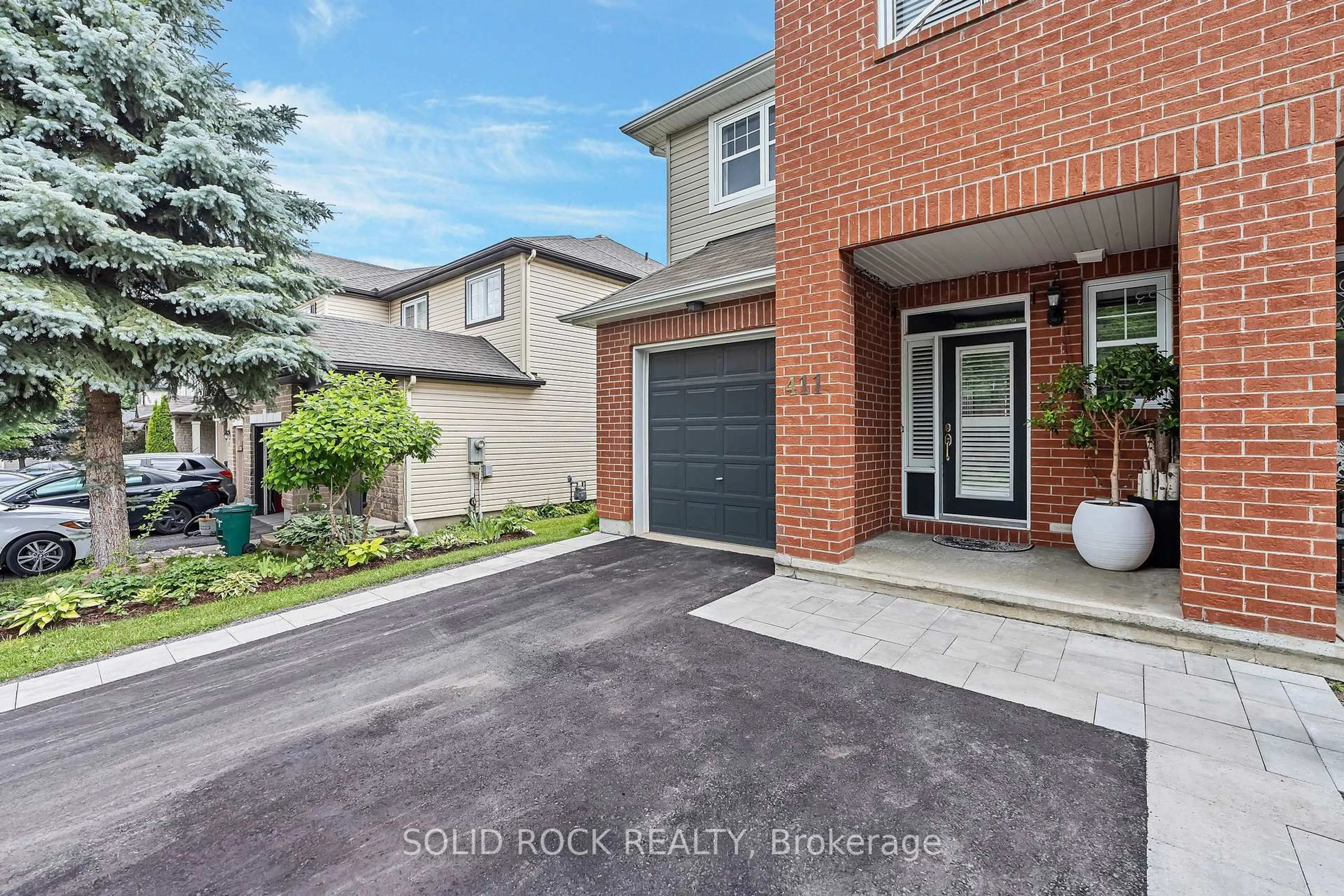 Home with brick exterior material, street for 411 Cache Bay Cres, Ottawa Ontario K1T 4H3