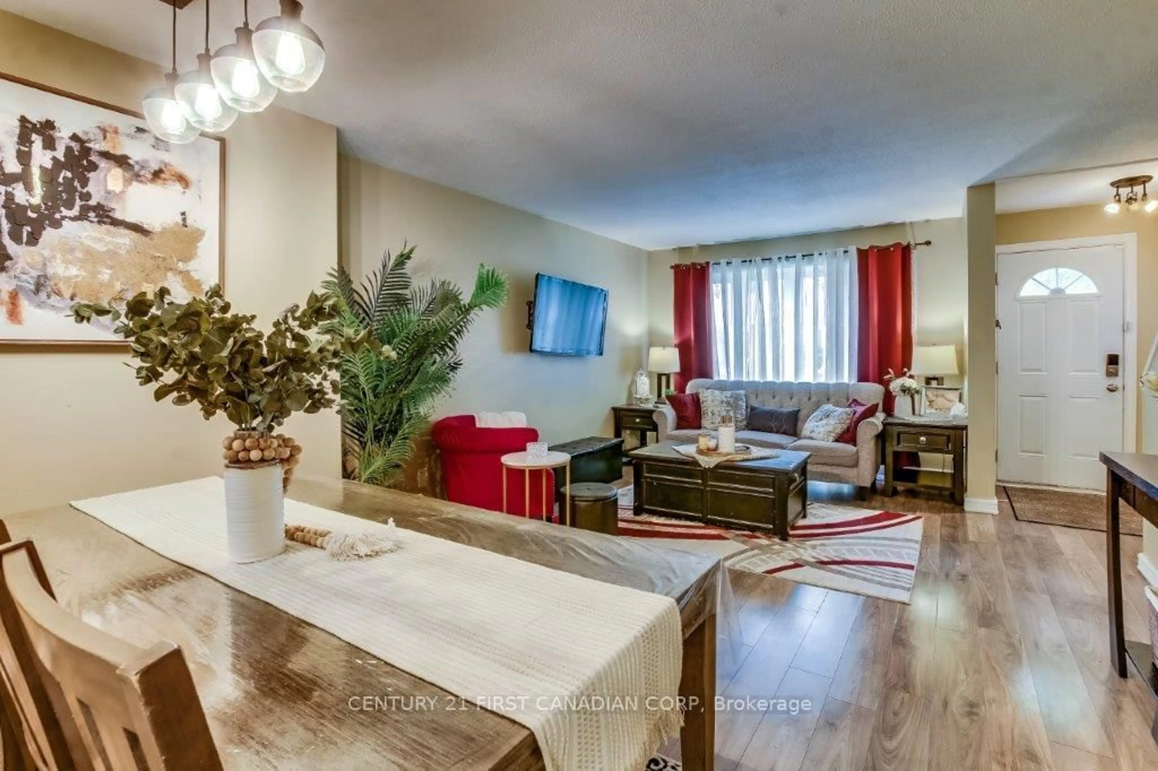 Living room with furniture, wood/laminate floor for 700 Exeter Rd #32, London South Ontario N6E 1L2