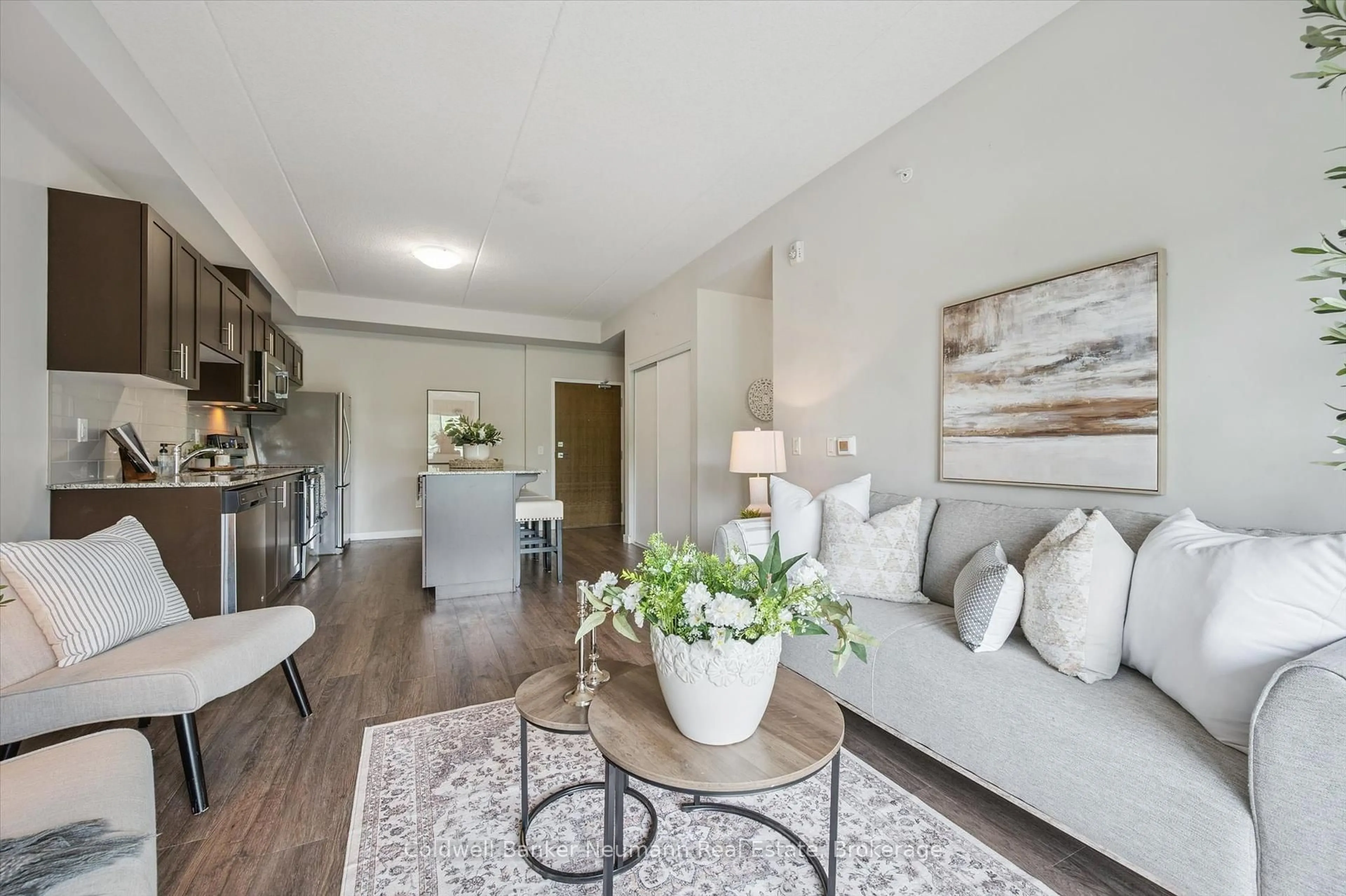 Living room with furniture, wood/laminate floor for 25 Kay Cres #108, Guelph Ontario N1L 0P2
