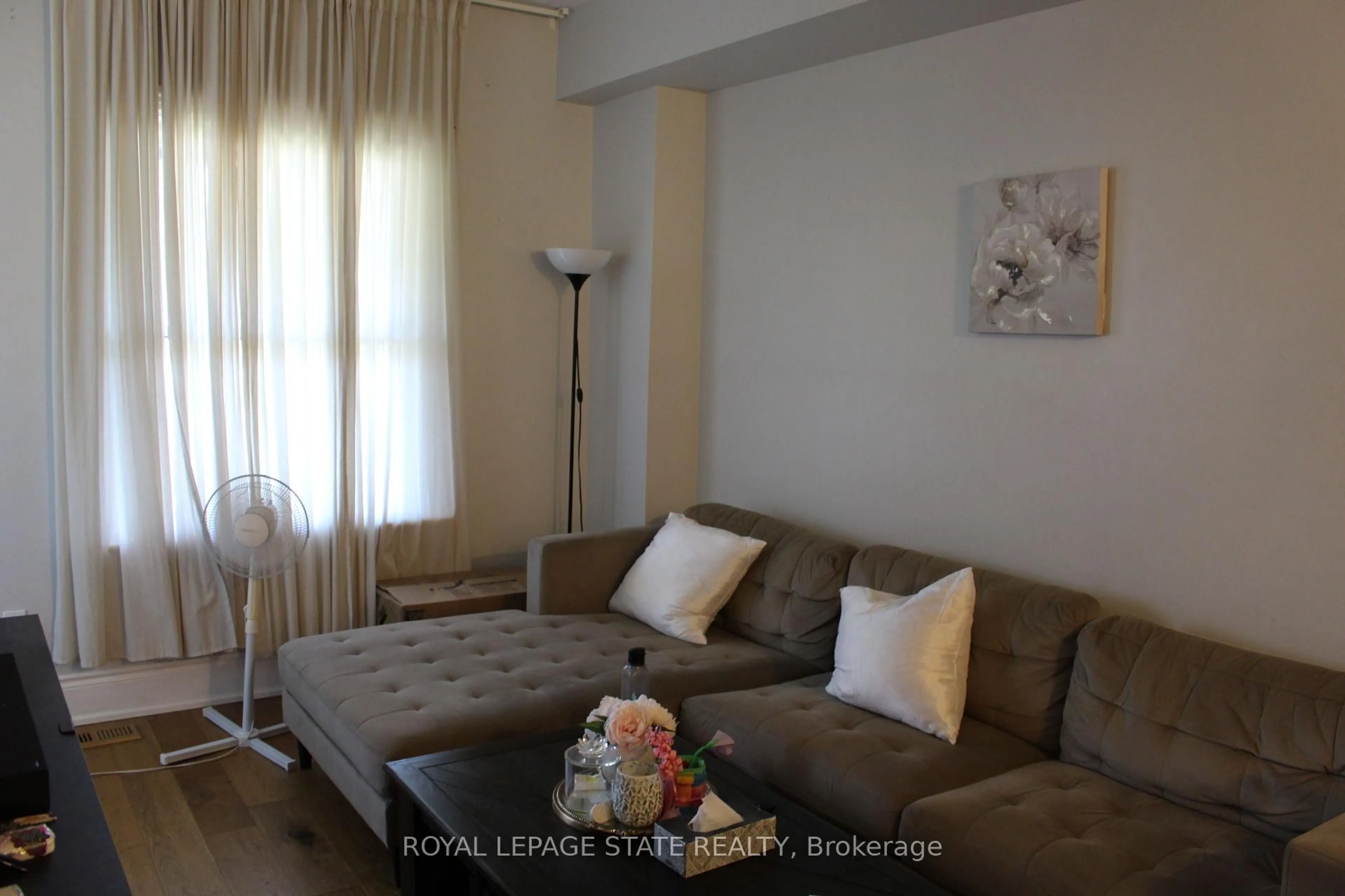 Living room with furniture, wood/laminate floor for 22 Burlington St, Hamilton Ontario L8L 4G2