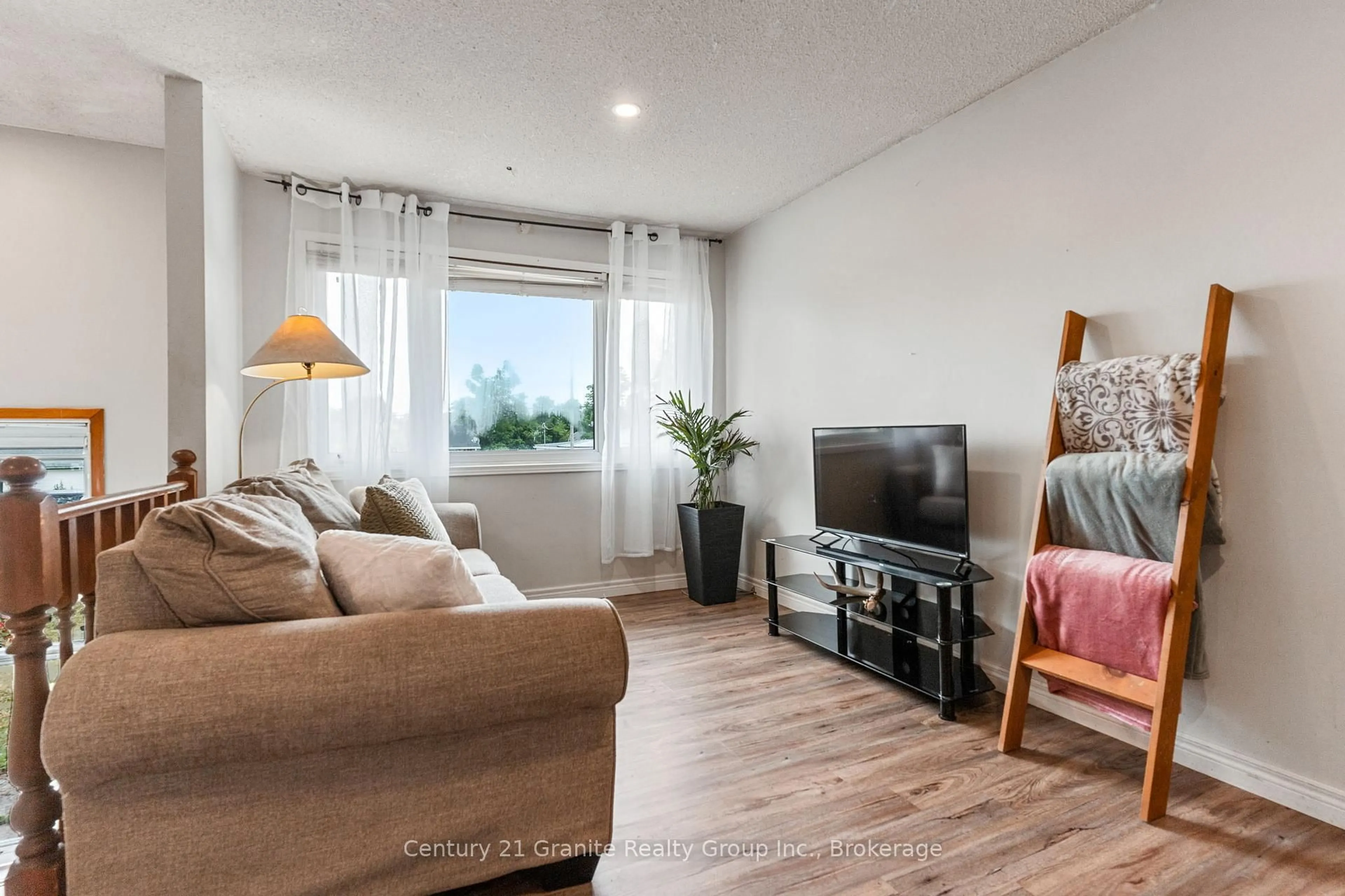 Living room with furniture, wood/laminate floor for 32 Cameron Rd, Kawartha Lakes Ontario K0M 1G0